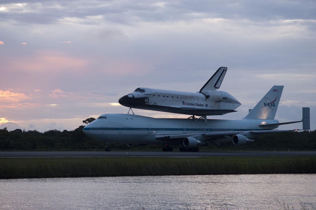 CAPE CANAVERAL, Fla. – Space shuttle Endeavour, mounted atop NASA's Shuttle Carrier Aircraft or SCA, taxis at the Shuttle Landing Facility at NASA's Kennedy Space Center in Florida. The SCA, a modified 747 jetliner, will fly Endeavour to Los Angeles where it will be placed on public display at the California Science Center. This is the final ferry flight scheduled in the Space Shuttle Program era. For more information on the shuttles' transition and retirement, visit http://www.nasa.gov/transition. Photo credit: NASA/Rick Wetherington