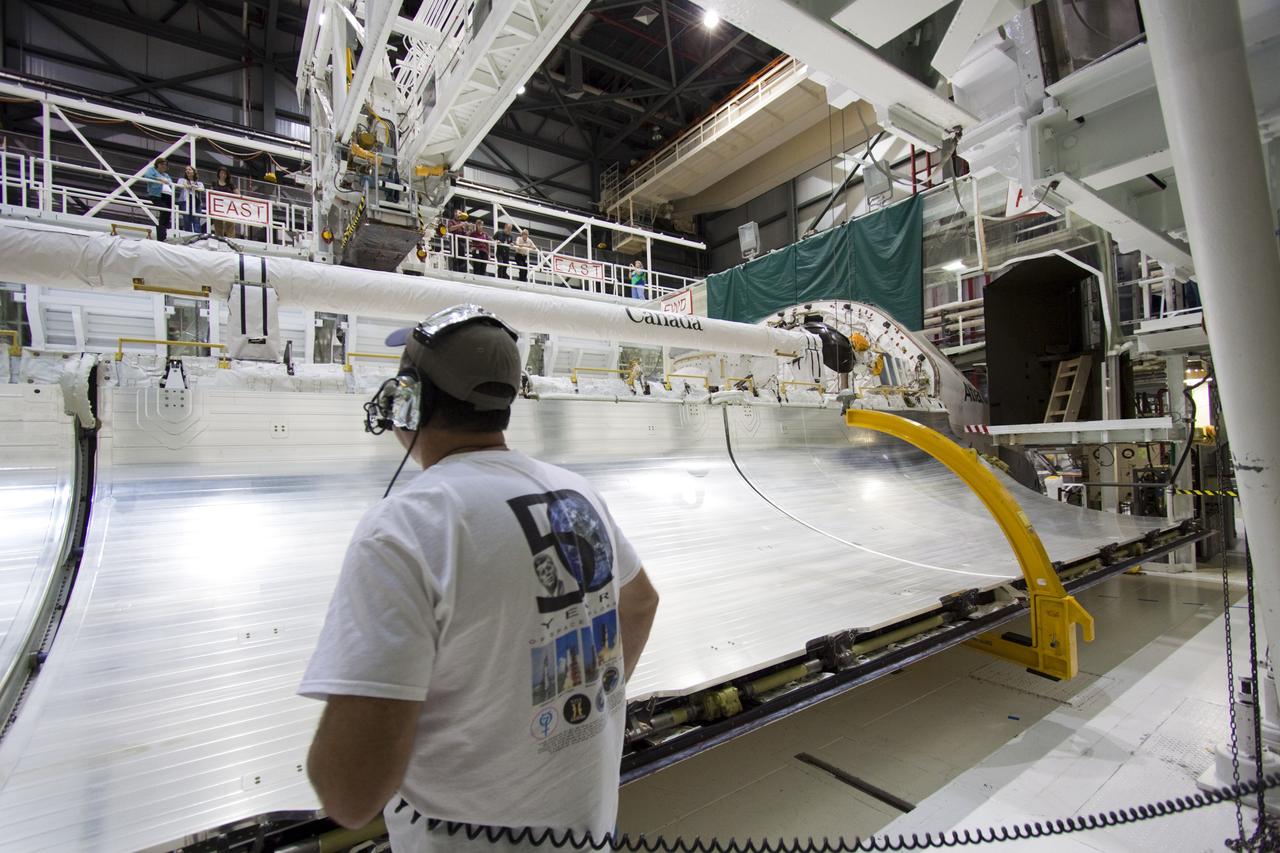 CAPE CANAVERAL, Fla. – Inside Orbiter Processing Facility-2 at NASA’s Kennedy Space Center in Florida, United Space Alliance Mid-body Mechanical Lead Tim Keyser, monitors space shuttle Atlantis’ left payload bay door as it begins to close. Both payload bay doors will be closed for the final time.    The orbiter is undergoing final preparations for its transfer to the Kennedy Space Center Visitor complex targeted for November. The work is part of Transition and Retirement of the remaining shuttle. Atlantis is being prepared for public display at the visitor complex. Over the course of its 26-year career, Atlantis spent 293 days in space during 33 missions. For more information, visit http://www.nasa.gov/transition. Photo credit: NASA/Jim Grossmann