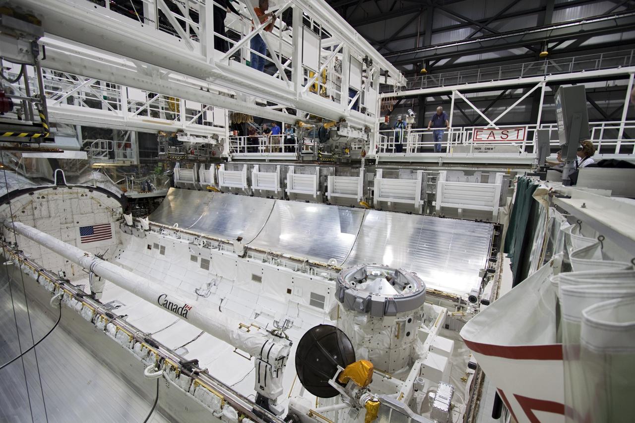 CAPE CANAVERAL, Fla. – Inside Orbiter Processing Facility-2 at NASA’s Kennedy Space Center in Florida, workers watch as the left payload bay door begins to close on space shuttle Atlantis. Both payload bay doors will be closed for the final time.    The orbiter is undergoing final preparations for its transfer to the Kennedy Space Center Visitor complex targeted for November. The work is part of Transition and Retirement of the remaining shuttle. Atlantis is being prepared for public display at the visitor complex. Over the course of its 26-year career, Atlantis spent 293 days in space during 33 missions. For more information, visit http://www.nasa.gov/transition. Photo credit: NASA/Jim Grossmann