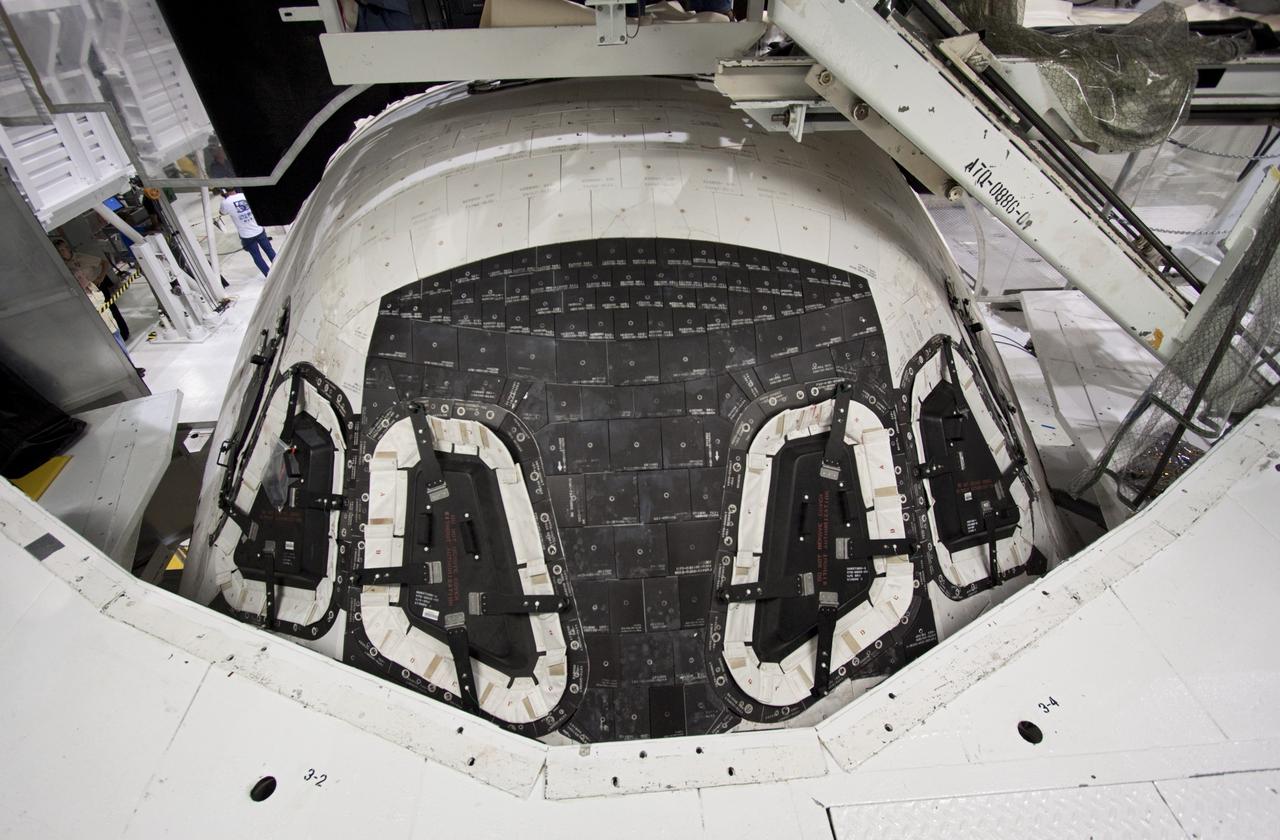 CAPE CANAVERAL, Fla. – Inside Orbiter Processing Facility-2 at NASA’s Kennedy Space Center in Florida, a view of space shuttle Atlantis’ nose cone is shown as the payload bay doors are closed for the final time.    The orbiter is undergoing final preparations for its transfer to the Kennedy Space Center Visitor complex targeted for November. The work is part of Transition and Retirement of the remaining shuttle. Atlantis is being prepared for public display at the visitor complex. Over the course of its 26-year career, Atlantis spent 293 days in space during 33 missions. For more information, visit http://www.nasa.gov/transition. Photo credit: NASA/Jim Grossmann