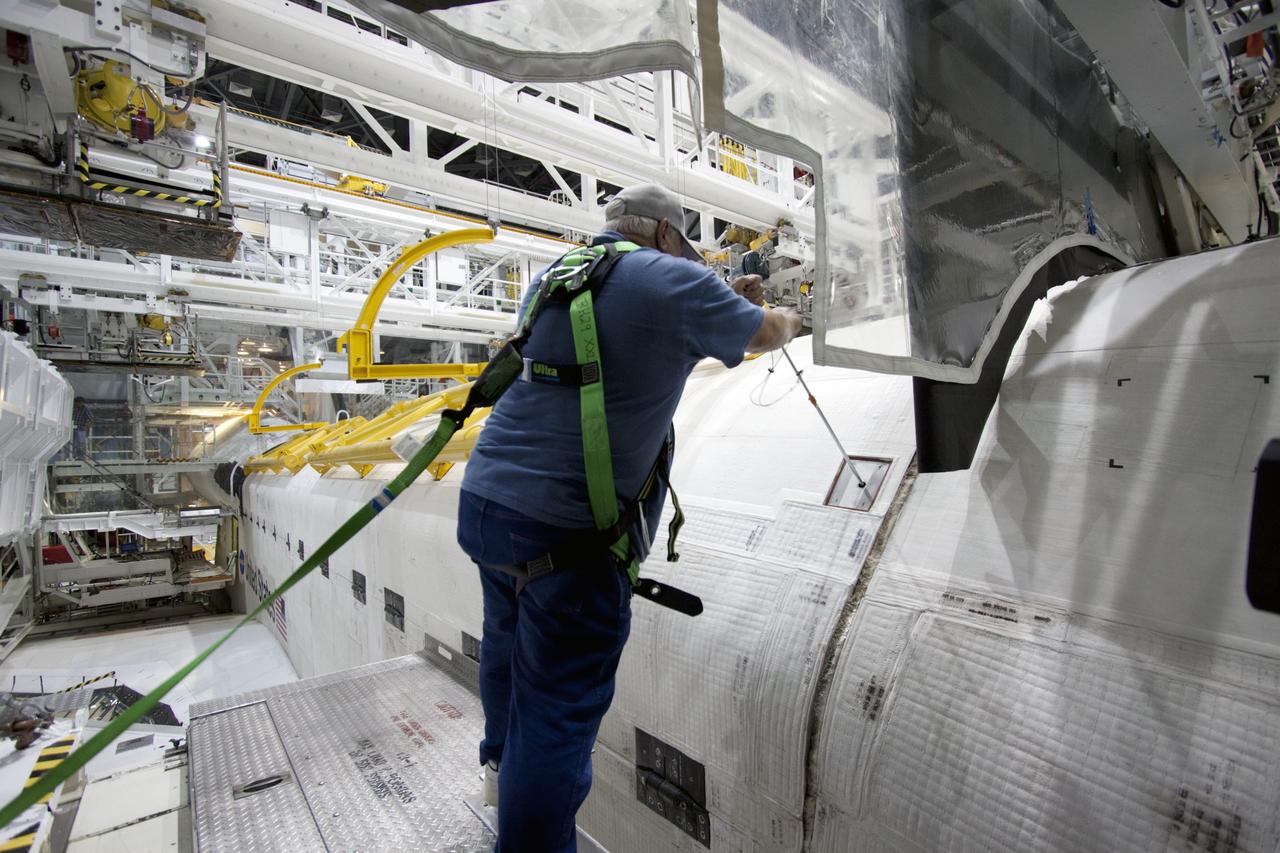 CAPE CANAVERAL, Fla. – Inside Orbiter Processing Facility-2 at NASA’s Kennedy Space Center in Florida, United Space Alliance technician Jim Reed uses a speed wrench in a gear box to lock the left payload bay door in place after it was closed. Both payload bay doors will be closed for the final time.    The orbiter is undergoing final preparations for its transfer to the Kennedy Space Center Visitor complex targeted for November. The work is part of Transition and Retirement of the remaining shuttle. Atlantis is being prepared for public display at the visitor complex. Over the course of its 26-year career, Atlantis spent 293 days in space during 33 missions. For more information, visit http://www.nasa.gov/transition. Photo credit: NASA/Jim Grossmann