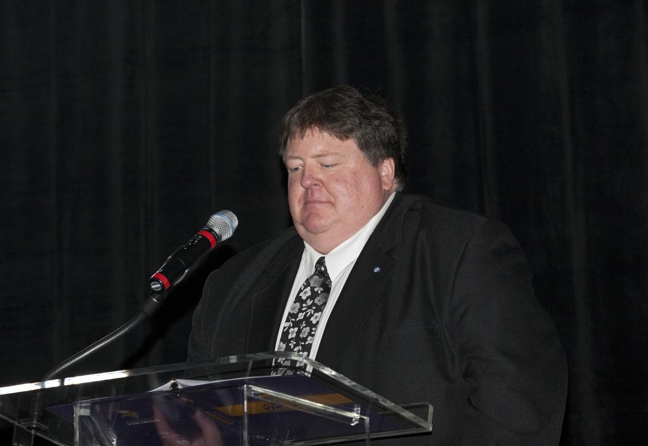 CAPE CANAVERAL, Fla. – Master of Ceremony Jim Banke, pauses during his opening remarks to attendees during NASA Kennedy Space Center’s 50th Anniversary Gala event at the Kennedy Space Center Visitor Complex Apollo/Saturn V Center in Florida. The gala was coordinated by Kennedy and the National Space Club Florida Committee with the theme, “Celebrating the Past and Preparing for the Future.”      The event was attended by about 650 current and retired NASA and contractor workers, dignitaries, and several former Kennedy Space Center directors. Photo credit: NASA/Kim Shiflett