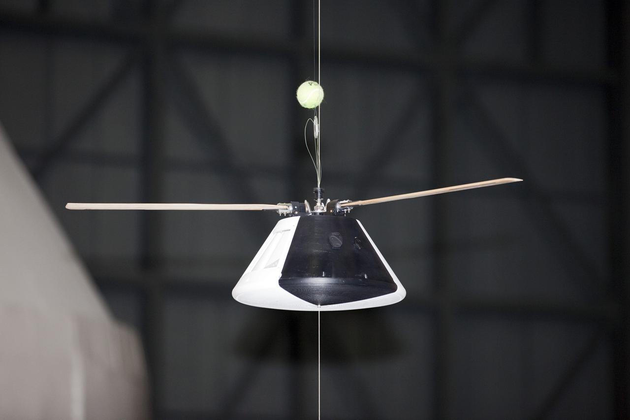 CAPE CANAVERAL, Fla. - A model capsule seen ahead of tests inside the Vehicle Assembly Building at NASA's Kennedy Space Center in Florida to test a rotor system landing design. The design would give a capsule the stability and control of a helicopter, but would not be powered. Instead, the wind passing over the rotors as the capsule descends would make the blades turn, a process called auto-rotation. The intent is to give real spacecraft a soft landing with enough control that they could touch down anywhere in the world, whether it be a runway or parking lot. In other words, wherever a helicopter could land, a spacecraft could land, too. Photo credit: NASA/Kim Shiflett