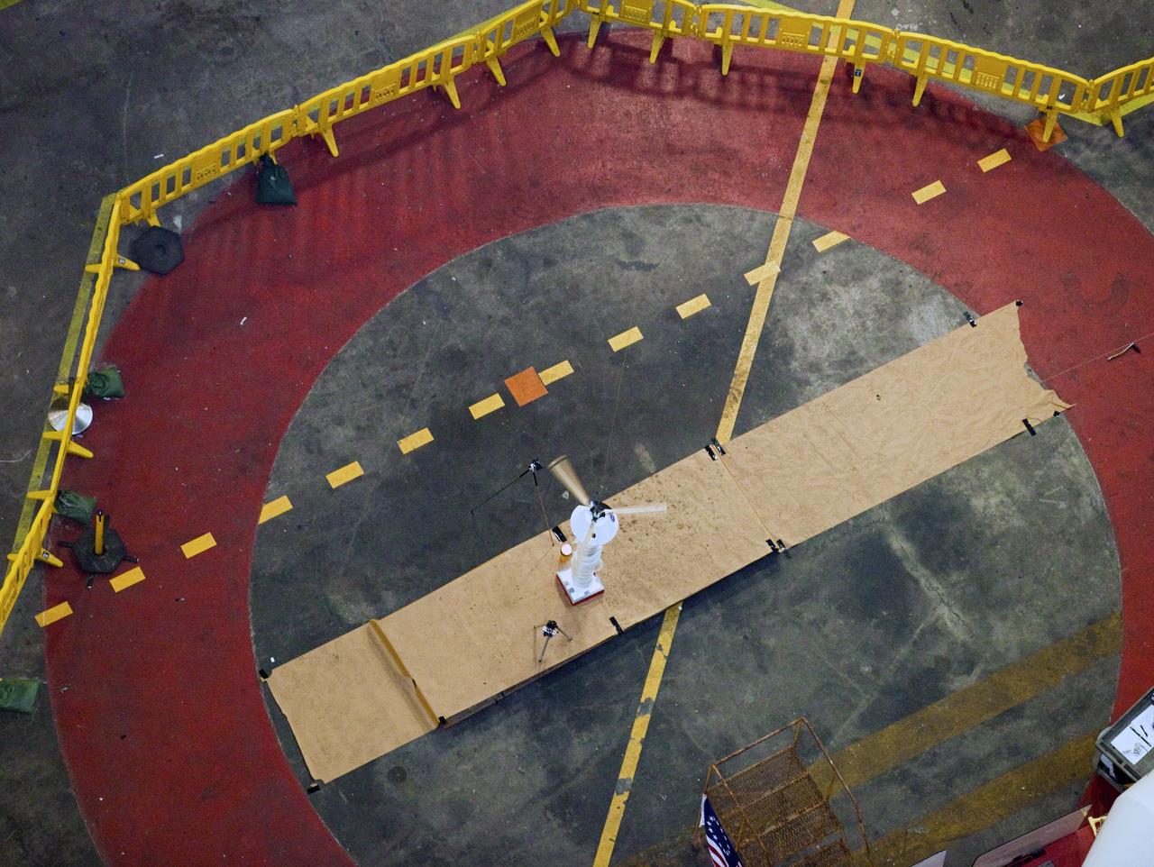CAPE CANAVERAL, Fla. - A model capsule falls during tests inside the Vehicle Assembly Building at NASA's Kennedy Space Center in Florida to test a rotor system landing design. The design would give a capsule the stability and control of a helicopter, but would not be powered. Instead, the wind passing over the rotors as the capsule descends would make the blades turn, a process called auto-rotation. The intent is to give real spacecraft a soft landing with enough control that they could touch down anywhere in the world, whether it be a runway or parking lot. In other words, wherever a helicopter could land, a spacecraft could land, too. Photo credit: NASA/Kim Shiflett