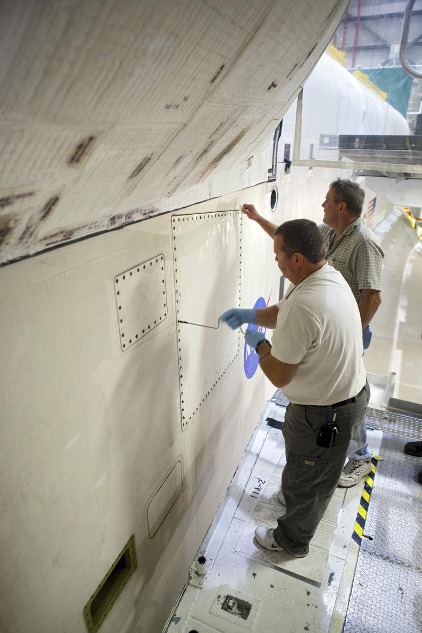 CAPE CANAVERAL, Fla. – Inside Orbiter Processing Facility-2 at NASA’s Kennedy Space Center in Florida, United Space Alliance technicians close space shuttle Atlantis’ midbody door for the final time. The orbiter is undergoing final preparations for its transfer to the Kennedy Space Center Visitor complex targeted for November. The work is part of Transition and Retirement of the remaining shuttle. Atlantis is being prepared for public display at the visitor complex. Over the course of its 26-year career, Atlantis spent 293 days in space during 33 missions. For more information, visit http://www.nasa.gov/transition. Photo credit: NASA/Dimitri Gerondidakis
