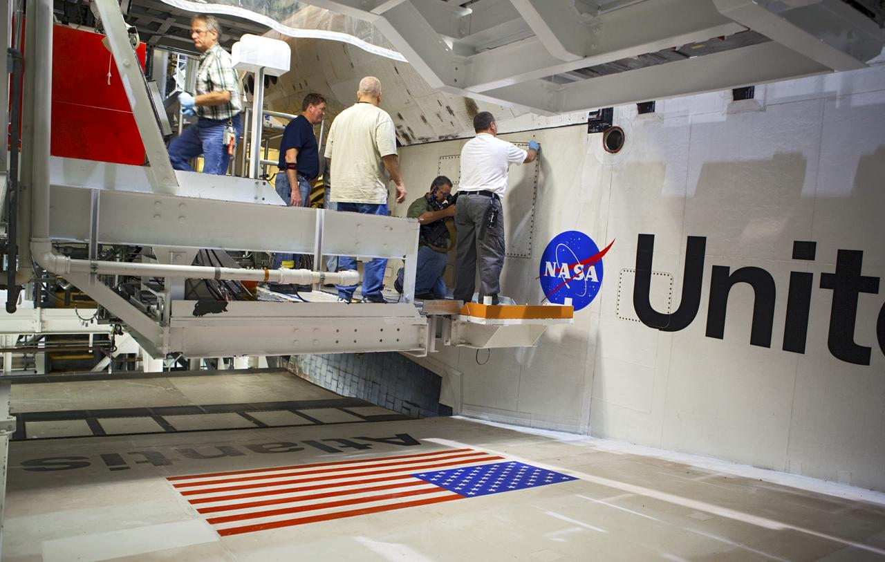 CAPE CANAVERAL, Fla. – Inside Orbiter Processing Facility-2 at NASA’s Kennedy Space Center in Florida, United Space Alliance technicians close space shuttle Atlantis’ midbody door for the final time.    The orbiter is undergoing final preparations for its transfer to the Kennedy Space Center Visitor complex targeted for November. The work is part of Transition and Retirement of the remaining shuttle. Atlantis is being prepared for public display at the visitor complex. Over the course of its 26-year career, Atlantis spent 293 days in space during 33 missions. For more information, visit http://www.nasa.gov/transition. Photo credit: NASA/Dimitri Gerondidakis