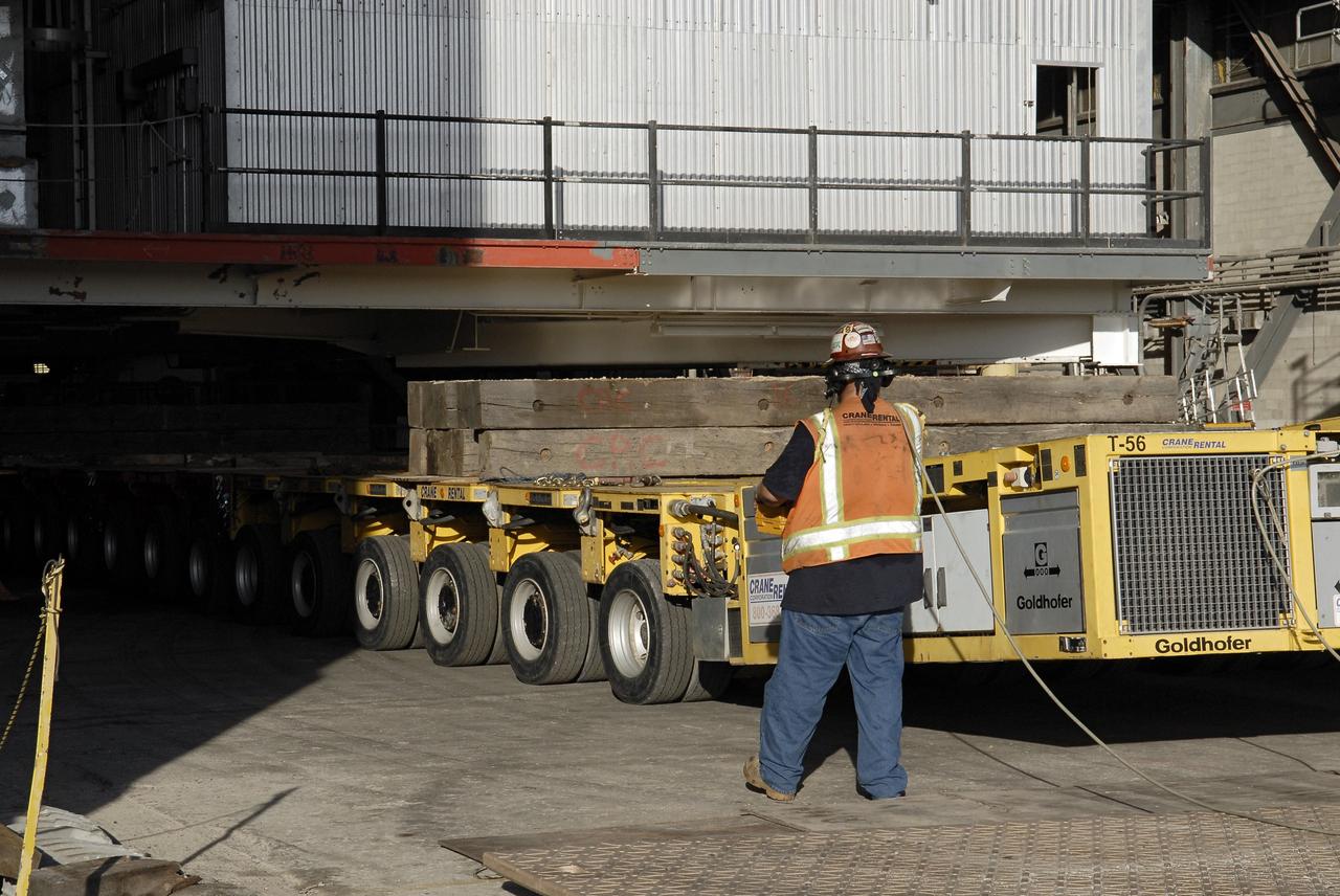 CAPE CANAVERAL, Fla. – As part of NASA's Ground Systems Development and Operations Program at the Kennedy Space Center in Florida, a technician oversees a large space shuttle-era work platform being removed from high bay 3 of the Vehicle Assembly Building, or VAB, and placed on a transporter for removal. The work is part of a center-wide modernization and refurbishment initiative to accommodate NASA’s Space Launch System and a variety of other spacecraft instead of the whole building supporting one design. The Ground Systems Development and Operations Program is developing the necessary ground systems, infrastructure and operational approaches required to safely process, assemble, transport and launch the next generation of rockets and spacecraft in support of NASA’s exploration objectives. Future work also will replace the antiquated communications, power and vehicle access resources with modern efficient systems. Some of the utilities and systems slated for replacement have been used since the VAB opened in 1965. For more information, visit http://www.nasa.gov/exploration/systems/ground/index.html Photo credit: NASA/ Charisse Nahser