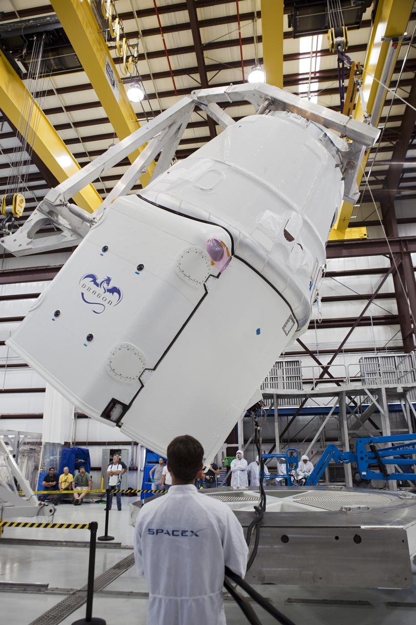 CAPE CANAVERAL, Fla. - Space Exploration Technologies, or SpaceX, technicians rotate a Dragon spacecraft for mating with its Falcon 9 launch vehicle. The rocket is being prepared for the company's first Commercial Resupply Services, or CRS-1, mission to the International Space Station. The capsule is scheduled to lift off on Oct. 7, 2012 from Space Launch Complex 40 at Cape Canaveral Air Force Station in Florida aboard a Falcon 9 rocket. The mission will be the company's second demonstration test flight for NASA's Commercial Orbital Transportation Services Program, or COTS. The SpaceX CRS contract with NASA provides for 12 cargo resupply missions to the station through 2015, the first of which is targeted to launch in October 2012.SpaceX became the first private company to berth a spacecraft with the space station in 2012 during its final demonstration flight under the Commercial Orbital Transportation Services, or COTS, program managed by NASA's Johnson Space Center in Houston. For more information, visit http://www.nasa.gov/mission_pages/station/living/launch/index.htmlPhoto credit: NASA/Ben Smegelsky