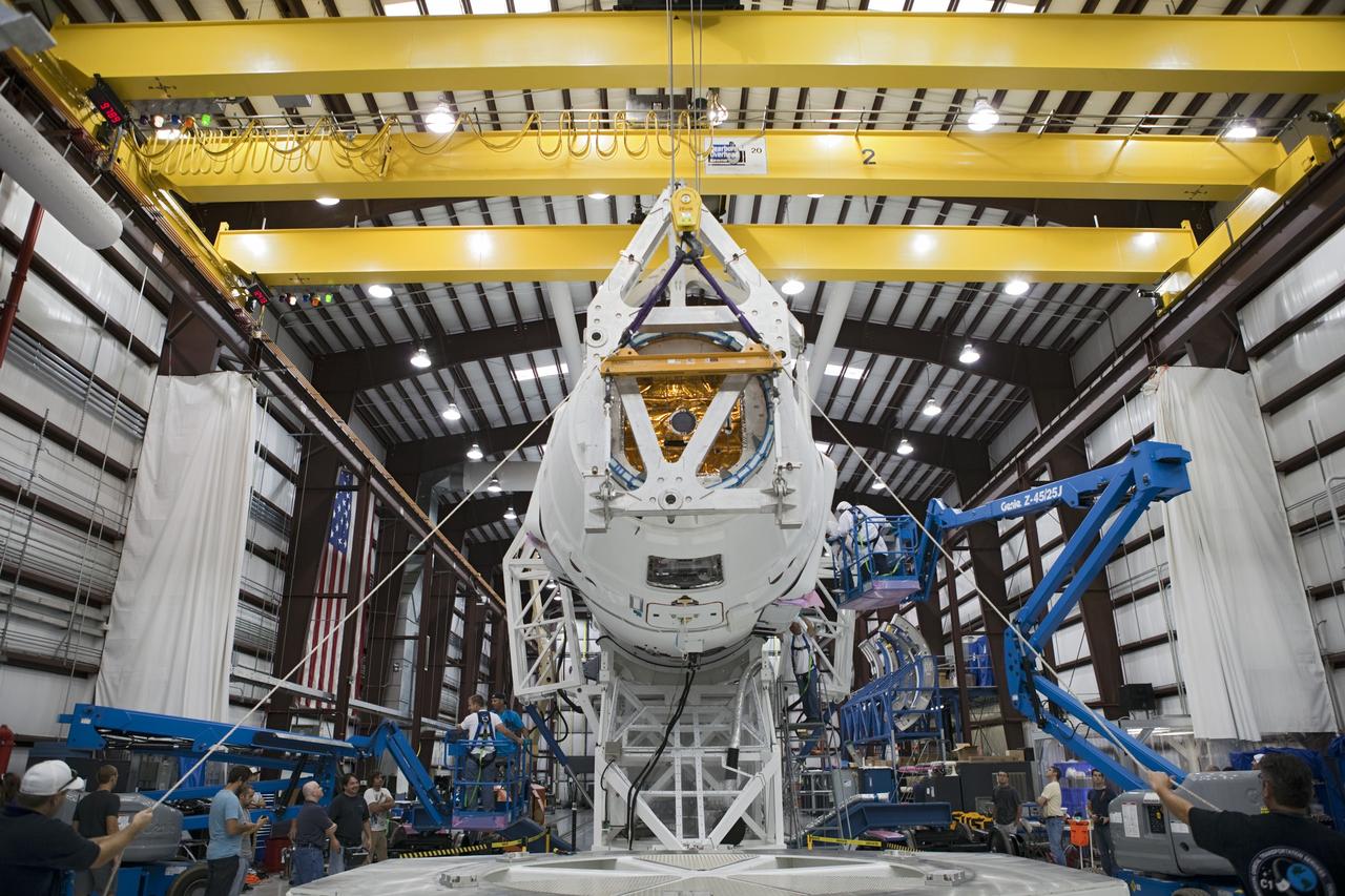 CAPE CANAVERAL, Fla. - Space Exploration Technologies, or SpaceX, technicians attach a Dragon spacecraft to its Falcon 9 launch vehicle. The rocket is being prepared for the company's first Commercial Resupply Services, or CRS-1, mission to the International Space Station. The capsule is scheduled to lift off on Oct. 7, 2012 from Space Launch Complex 40 at Cape Canaveral Air Force Station in Florida aboard a Falcon 9 rocket. The mission will be the company's second demonstration test flight for NASA's Commercial Orbital Transportation Services Program, or COTS. The SpaceX CRS contract with NASA provides for 12 cargo resupply missions to the station through 2015, the first of which is targeted to launch in October 2012.SpaceX became the first private company to berth a spacecraft with the space station in 2012 during its final demonstration flight under the Commercial Orbital Transportation Services, or COTS, program managed by NASA's Johnson Space Center in Houston. For more information, visit http://www.nasa.gov/mission_pages/station/living/launch/index.htmlPhoto credit: NASA/Ben Smegelsky