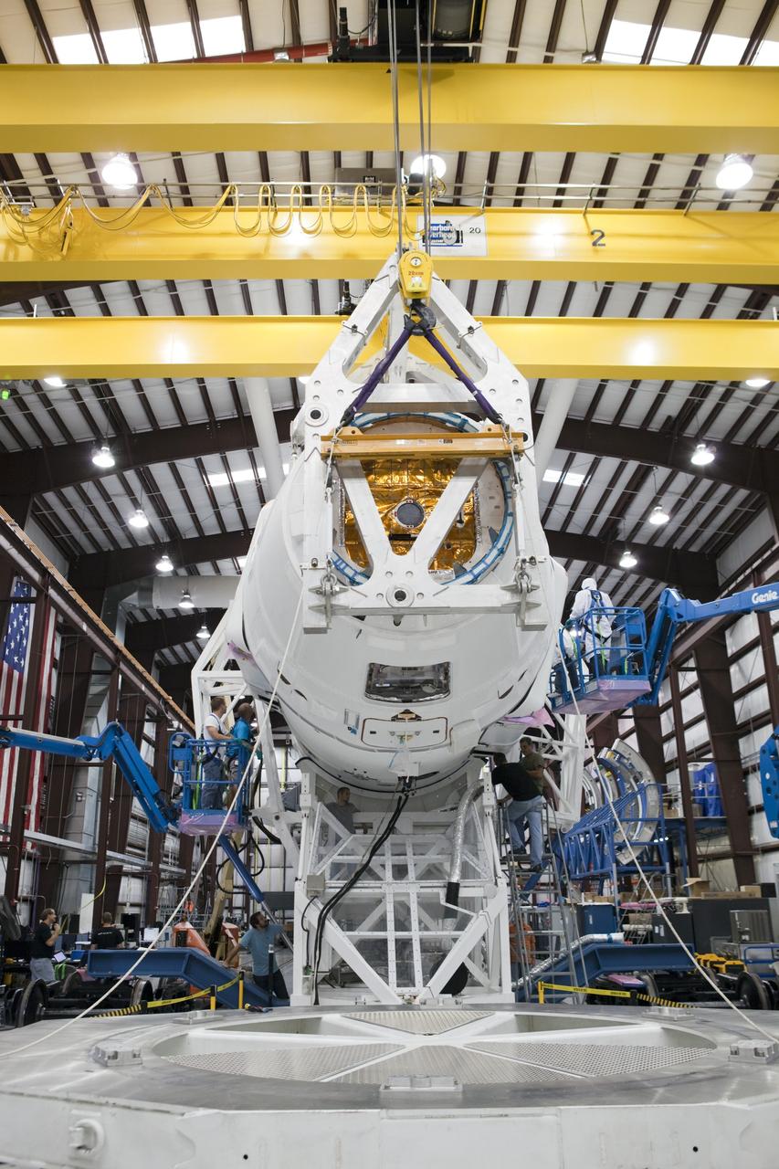 CAPE CANAVERAL, Fla. - Space Exploration Technologies, or SpaceX, technicians use lifts to inspect a Dragon spacecraft as it is being attached to its Falcon 9 launch vehicle. The rocket is being prepared for the company's first Commercial Resupply Services, or CRS-1, mission to the International Space Station. The capsule is scheduled to lift off on Oct. 7, 2012 from Space Launch Complex 40 at Cape Canaveral Air Force Station in Florida aboard a Falcon 9 rocket. The mission will be the company's second demonstration test flight for NASA's Commercial Orbital Transportation Services Program, or COTS. The SpaceX CRS contract with NASA provides for 12 cargo resupply missions to the station through 2015, the first of which is targeted to launch in October 2012.SpaceX became the first private company to berth a spacecraft with the space station in 2012 during its final demonstration flight under the Commercial Orbital Transportation Services, or COTS, program managed by NASA's Johnson Space Center in Houston. For more information, visit http://www.nasa.gov/mission_pages/station/living/launch/index.htmlPhoto credit: NASA/Ben Smegelsky