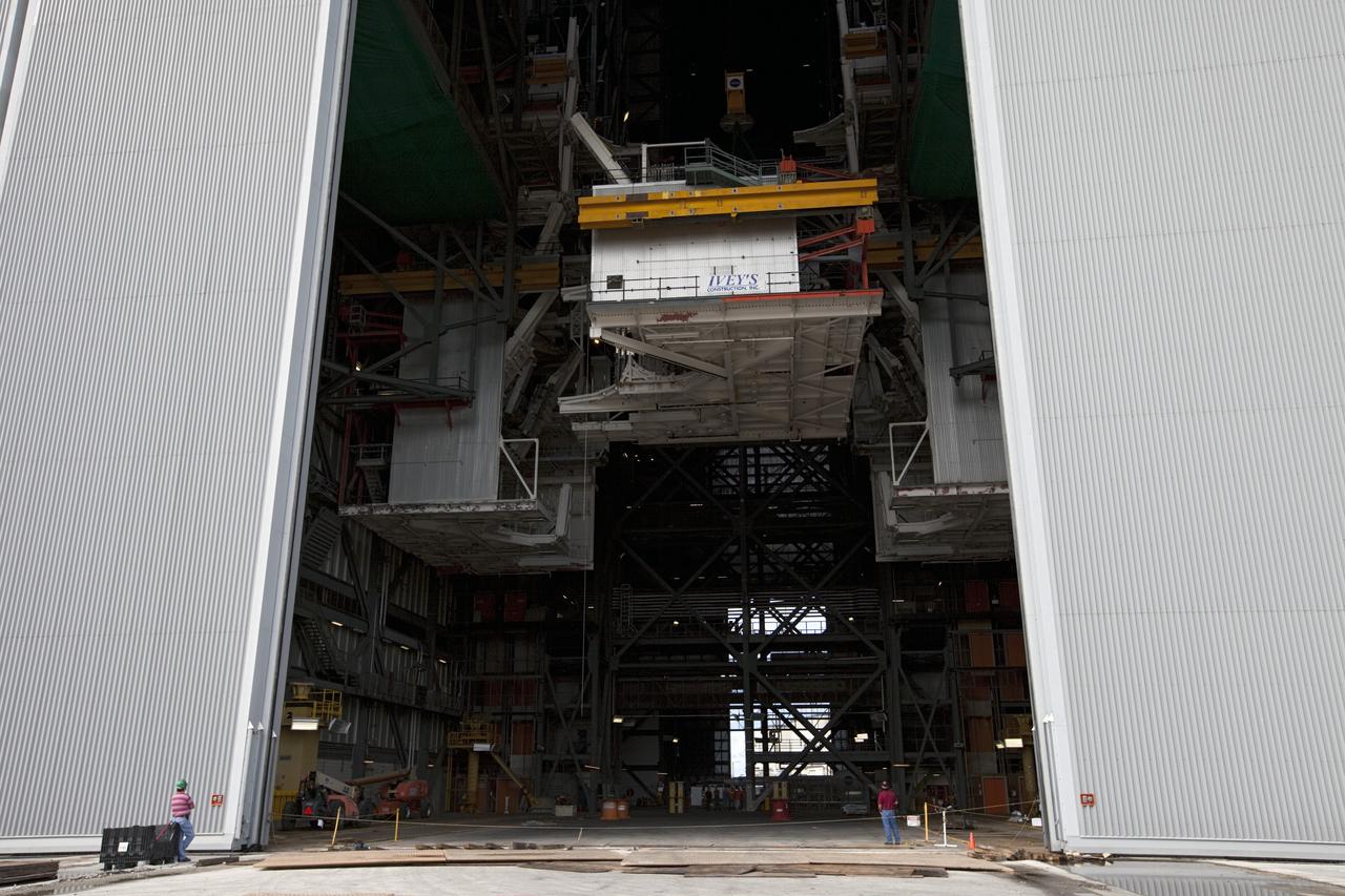 CAPE CANAVERAL, Fla. -- At NASA’s Kennedy Space Center in Florida, construction workers lower the large space shuttle-era Level E north work platform from high bay 3 inside the Vehicle Assembly Building, or VAB. The platform will be moved to the VAB north parking area for temporary storage.    The work is part of a center-wide refurbishment initiative under the Ground Systems Development and Operations, or GSDO, Program. High bay 3 is being refurbished to accommodate NASA’s Space Launch System and a variety of other spacecraft.  For more information, visit http://www.nasa.gov/exploration/systems/ground/index.html. Photo credit: NASA/Kim Shiflett
