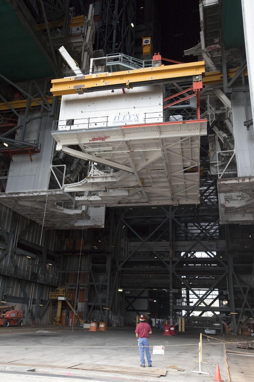 CAPE CANAVERAL, Fla. -- At NASA’s Kennedy Space Center in Florida, construction workers lower the large space shuttle-era Level E north work platform from high bay 3 inside the Vehicle Assembly Building, or VAB. The platform will be moved to the VAB north parking area for temporary storage.    The work is part of a center-wide refurbishment initiative under the Ground Systems Development and Operations, or GSDO, Program. High bay 3 is being refurbished to accommodate NASA’s Space Launch System and a variety of other spacecraft.  For more information, visit http://www.nasa.gov/exploration/systems/ground/index.html. Photo credit: NASA/Kim Shiflett