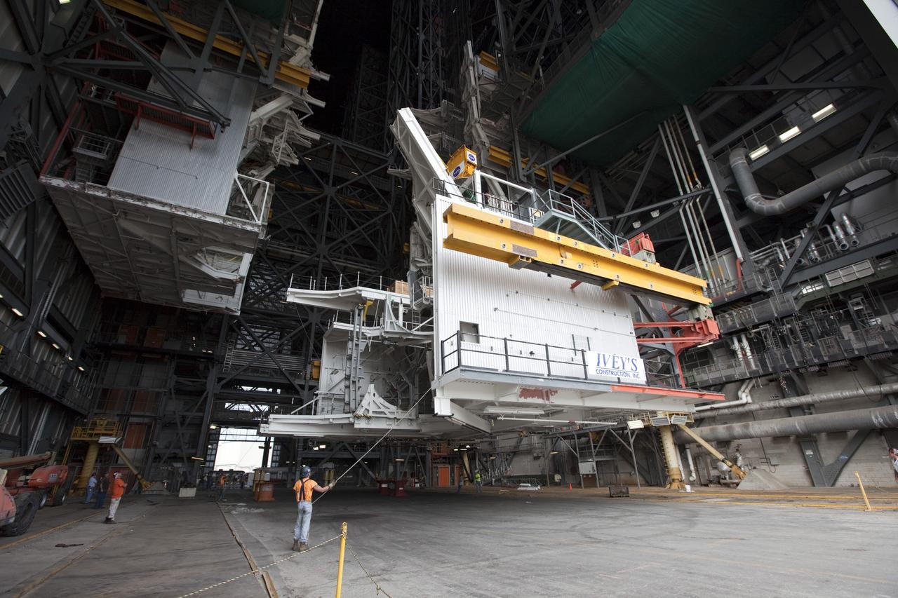 CAPE CANAVERAL, Fla. -- At NASA’s Kennedy Space Center in Florida, construction workers lower the large space shuttle-era Level E north work platform from high bay 3 inside the Vehicle Assembly Building, or VAB. The platform will be moved to the VAB north parking area for temporary storage.    The work is part of a center-wide refurbishment initiative under the Ground Systems Development and Operations, or GSDO, Program. High bay 3 is being refurbished to accommodate NASA’s Space Launch System and a variety of other spacecraft.  For more information, visit http://www.nasa.gov/exploration/systems/ground/index.html. Photo credit: NASA/Kim Shiflett