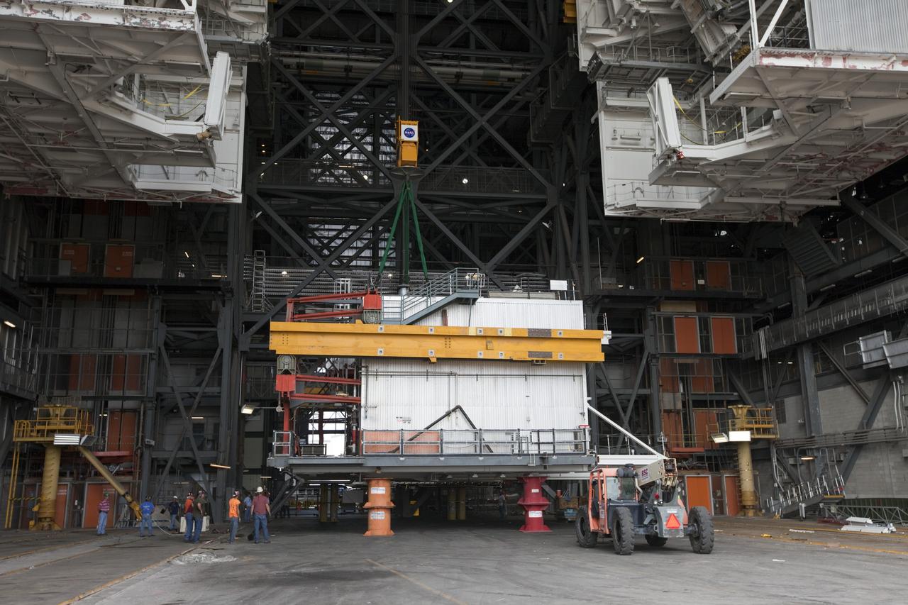 CAPE CANAVERAL, Fla. -- At NASA’s Kennedy Space Center in Florida, construction workers lower the large space shuttle-era Level E north work platform from high bay 3 inside the Vehicle Assembly Building, or VAB. The platform will be moved to the VAB north parking area for temporary storage.    The work is part of a center-wide refurbishment initiative under the Ground Systems Development and Operations, or GSDO, Program. High bay 3 is being refurbished to accommodate NASA’s Space Launch System and a variety of other spacecraft.  For more information, visit http://www.nasa.gov/exploration/systems/ground/index.html. Photo credit: NASA/Kim Shiflett