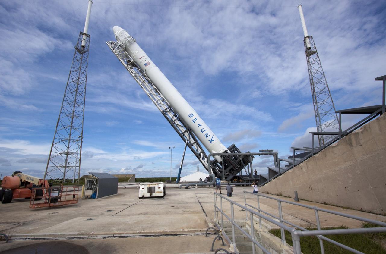 CAPE CANAVERAL, Fla. -- The Space Exploration Technologies Corp., or SpaceX, Falcon 9 rocket with Dragon capsule attached on top is lifted into the vertical position during a rollout demonstration test at Space Launch Complex-40 at Cape Canaveral Air Force Station in Florida. Preparations continue for NASA’s first Commercial Resupply Services, or CRS-1, mission to the International Space Station.    The rollout to the pad for liftoff is planned for Sunday morning, Oct. 7. Liftoff from CCAFS is scheduled during an instantaneous window at 8:35 p.m. EDT Sunday evening. SpaceX CRS-1 is an important step toward making America’s microgravity research program self-sufficient by providing a way to deliver and return significant amounts of cargo, including science experiments, to and from the orbiting laboratory. To learn more, visit http://www.nasa.gov/mission_pages/station/living/launch/index.html. Photo credit: NASA/Jim Grossmann