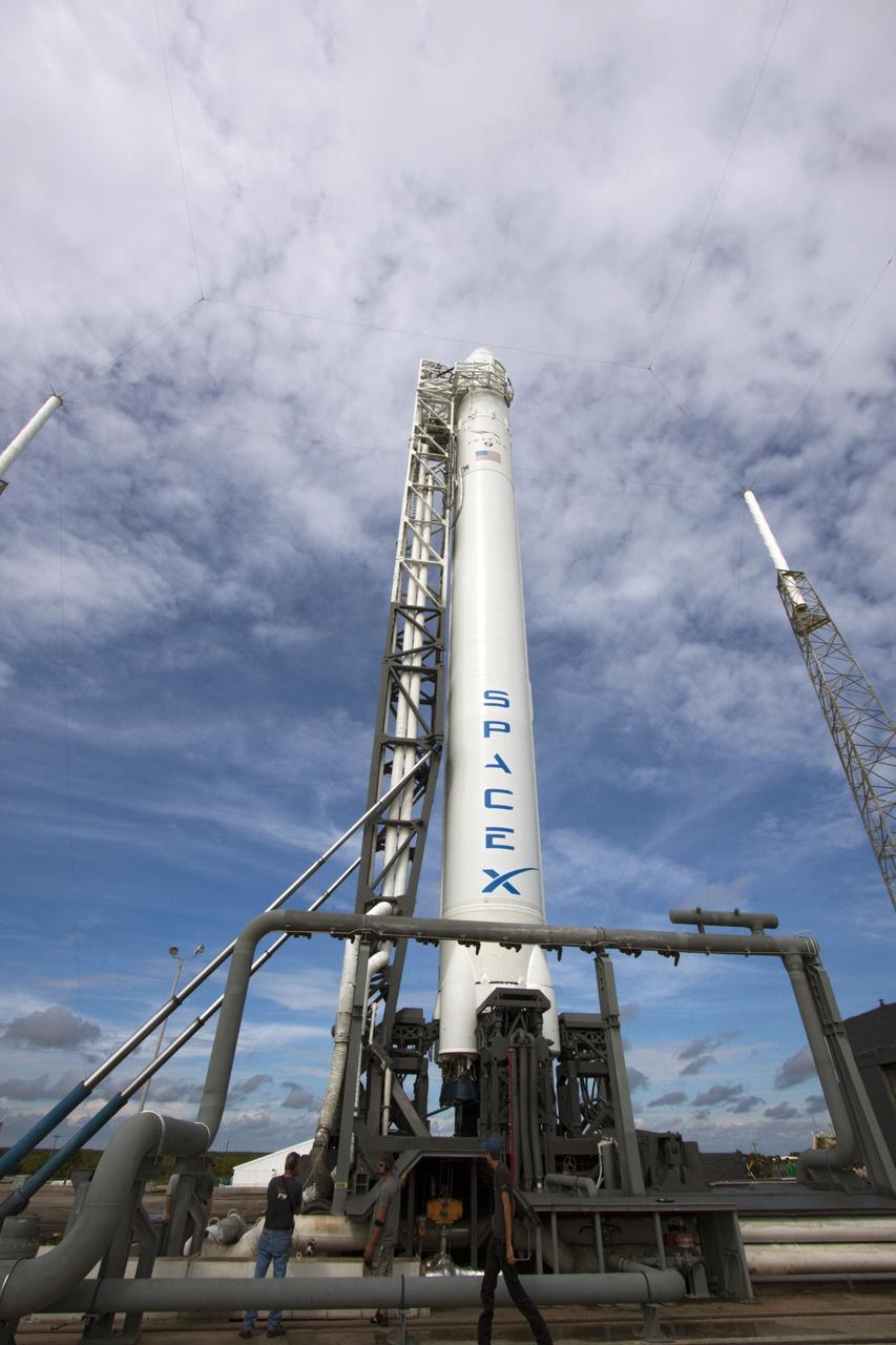 CAPE CANAVERAL, Fla. -- The Space Exploration Technologies Corp., or SpaceX, Falcon 9 rocket with Dragon capsule attached on top is lifted into the vertical position during a rollout demonstration test at Space Launch Complex-40 at Cape Canaveral Air Force Station in Florida. Preparations continue for NASA’s first Commercial Resupply Services, or CRS-1, mission to the International Space Station.    The rollout to the pad for liftoff is planned for Sunday morning, Oct. 7. Liftoff from CCAFS is scheduled during an instantaneous window at 8:35 p.m. EDT Sunday evening. SpaceX CRS-1 is an important step toward making America’s microgravity research program self-sufficient by providing a way to deliver and return significant amounts of cargo, including science experiments, to and from the orbiting laboratory. To learn more, visit http://www.nasa.gov/mission_pages/station/living/launch/index.html. Photo credit: NASA/Jim Grossmann