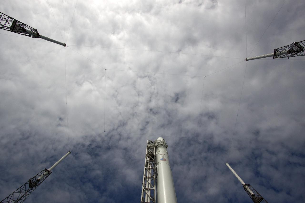 CAPE CANAVERAL, Fla. -- A unique view from the ground looking up shows the Space Exploration Technologies Corp., or SpaceX, Falcon 9 rocket with Dragon capsule attached after it was lifted into the vertical position during a rollout demonstration test to Space Launch Complex-40 at Cape Canaveral Air Force Station in Florida. Preparations continue for NASA’s first Commercial Resupply Services, or CRS-1, mission to the International Space Station.    The rollout to the pad for liftoff is planned for Sunday morning, Oct. 7. Liftoff from CCAFS is scheduled during an instantaneous window at 8:35 p.m. EDT Sunday evening. SpaceX CRS-1 is an important step toward making America’s microgravity research program self-sufficient by providing a way to deliver and return significant amounts of cargo, including science experiments, to and from the orbiting laboratory. To learn more, visit http://www.nasa.gov/mission_pages/station/living/launch/index.html. Photo credit: NASA/Jim Grossmann