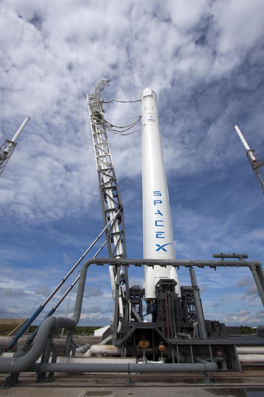 CAPE CANAVERAL, Fla. -- The Space Exploration Technologies Corp., or SpaceX, Falcon 9 rocket with Dragon capsule atop is in the vertical position with associated launch pad umbilicals attached, during a rollout demonstration test at Space Launch Complex-40 at Cape Canaveral Air Force Station in Florida. Preparations continue for NASA’s first Commercial Resupply Services, or CRS-1, mission to the International Space Station.    The rollout to the pad for liftoff is planned for Sunday morning, Oct. 7. Liftoff from CCAFS is scheduled during an instantaneous window at 8:35 p.m. EDT Sunday evening. SpaceX CRS-1 is an important step toward making America’s microgravity research program self-sufficient by providing a way to deliver and return significant amounts of cargo, including science experiments, to and from the orbiting laboratory. To learn more, visit http://www.nasa.gov/mission_pages/station/living/launch/index.html. Photo credit: NASA/Jim Grossmann