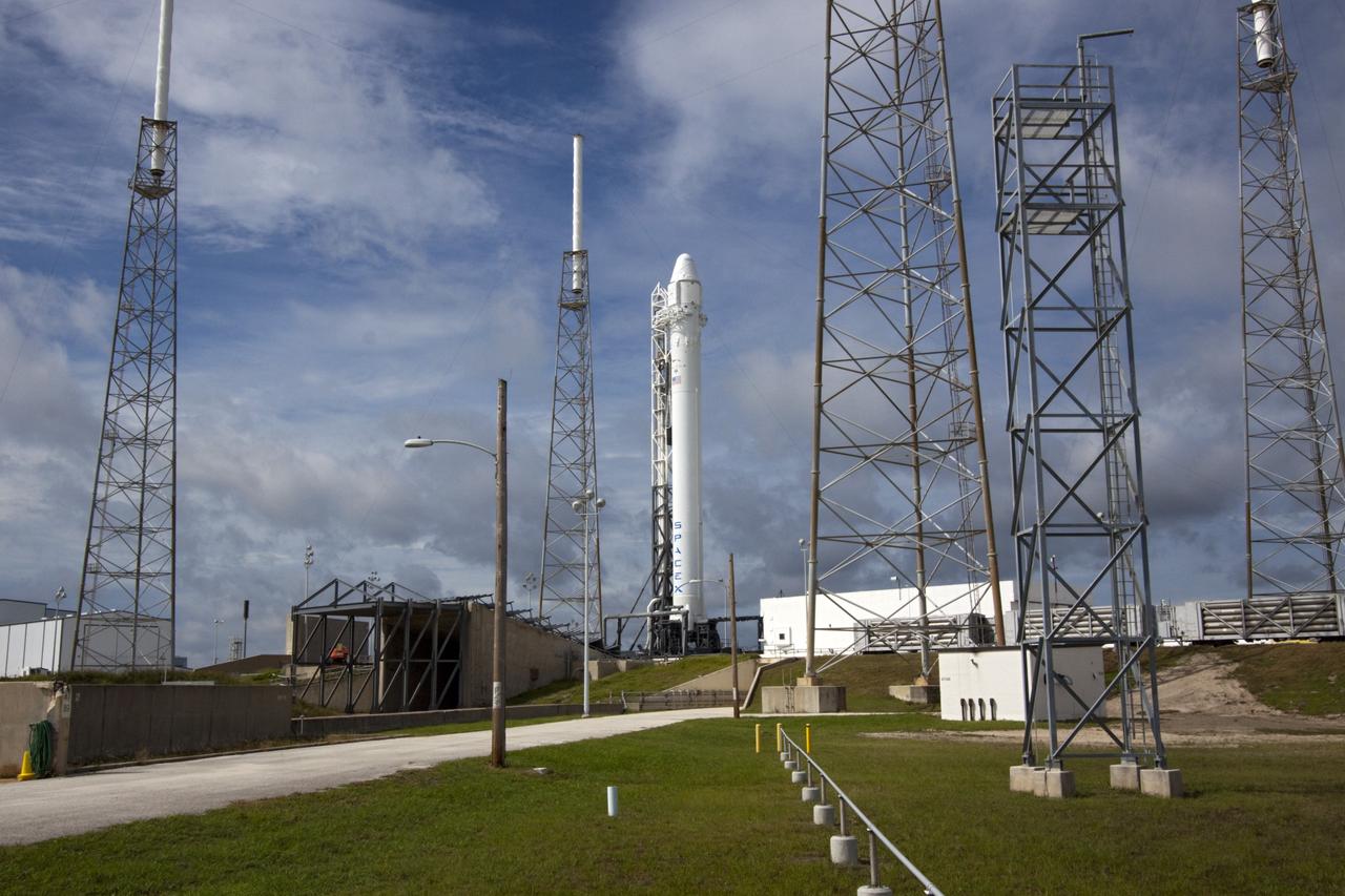 CAPE CANAVERAL, Fla. -- The Space Exploration Technologies Corp., or SpaceX, Falcon 9 rocket with Dragon capsule attached on top sits in the vertical position during a rollout demonstration test at Space Launch Complex-40 at Cape Canaveral Air Force Station in Florida. Preparations continue for NASA’s first Commercial Resupply Services, or CRS-1, mission to the International Space Station.    The rollout to the pad for liftoff is planned for Sunday morning, Oct. 7. Liftoff from CCAFS is scheduled during an instantaneous window at 8:35 p.m. EDT Sunday evening. SpaceX CRS-1 is an important step toward making America’s microgravity research program self-sufficient by providing a way to deliver and return significant amounts of cargo, including science experiments, to and from the orbiting laboratory. To learn more, visit http://www.nasa.gov/mission_pages/station/living/launch/index.html. Photo credit: NASA/Jim Grossmann