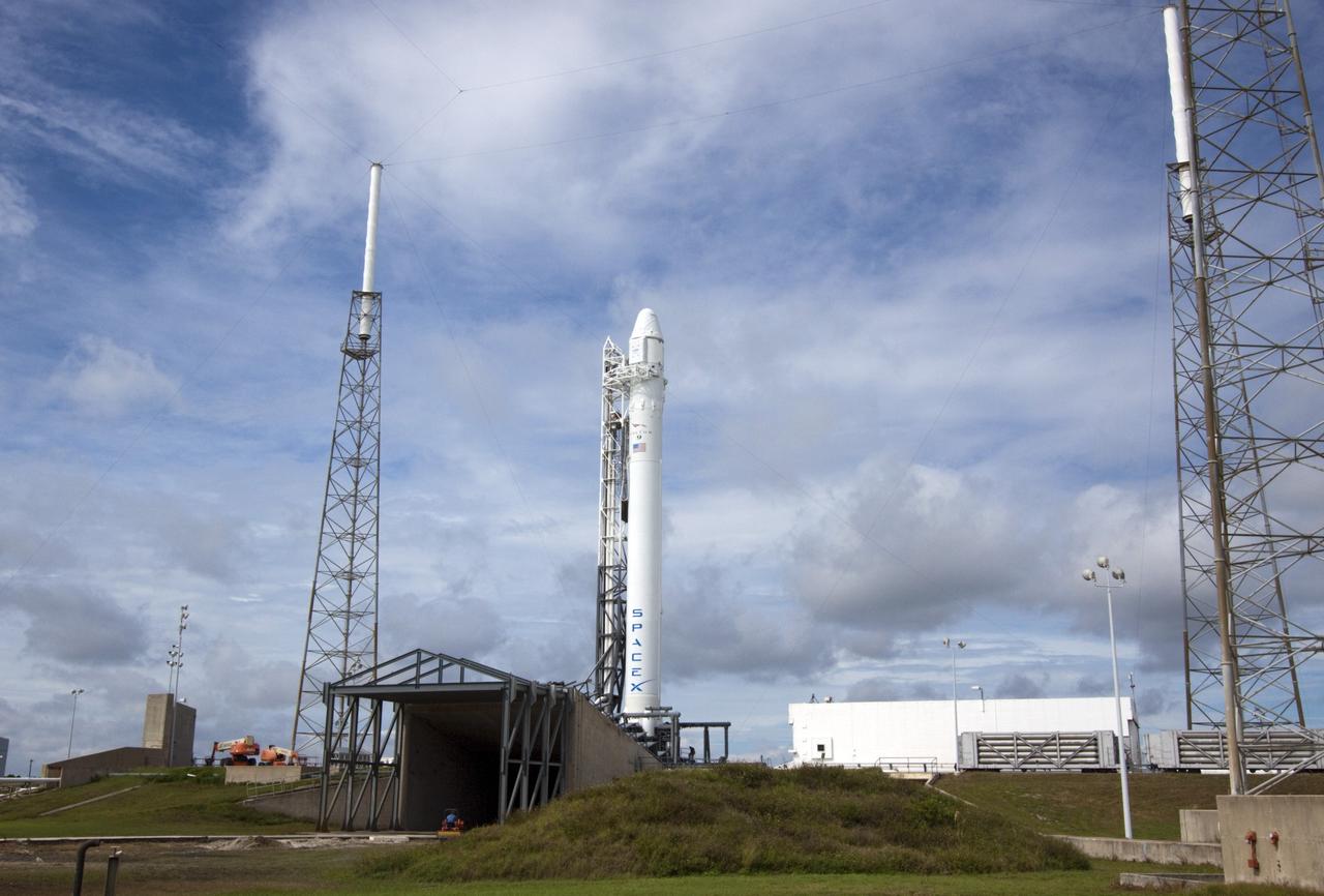 CAPE CANAVERAL, Fla. -- The Space Exploration Technologies Corp., or SpaceX, Falcon 9 rocket with Dragon capsule attached on top sits in the vertical position during a rollout demonstration test at Space Launch Complex-40 at Cape Canaveral Air Force Station in Florida. Preparations continue for NASA’s first Commercial Resupply Services, or CRS-1, mission to the International Space Station.    The rollout to the pad for liftoff is planned for Sunday morning, Oct. 7. Liftoff from CCAFS is scheduled during an instantaneous window at 8:35 p.m. EDT Sunday evening. SpaceX CRS-1 is an important step toward making America’s microgravity research program self-sufficient by providing a way to deliver and return significant amounts of cargo, including science experiments, to and from the orbiting laboratory. To learn more, visit http://www.nasa.gov/mission_pages/station/living/launch/index.html. Photo credit: NASA/Jim Grossmann