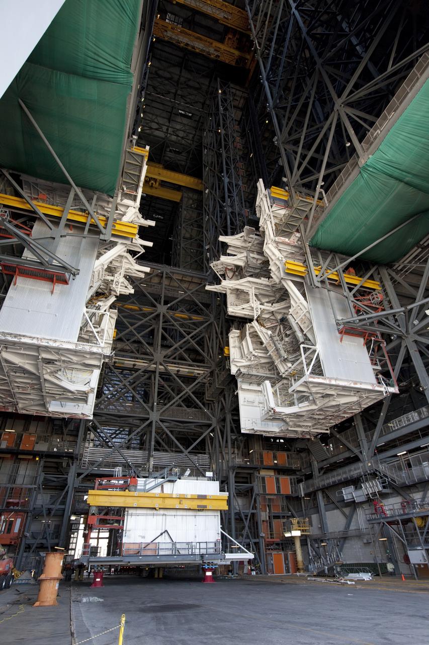CAPE CANAVERAL, Fla. – At NASA’s Kennedy Space Center in Florida, a crane lifts a space shuttle-era work platform from high bay 3 inside the Vehicle Assembly Building, or VAB. The platform has been moved to the VAB north parking area for temporary storage. The work is part of a center-wide refurbishment initiative under the Ground Systems Development and Operations, or GSDO, Program. High bay 3 is being refurbished to accommodate NASA’s Space Launch System and a variety of other spacecraft. Photo credit: NASA/Kim Shiflett