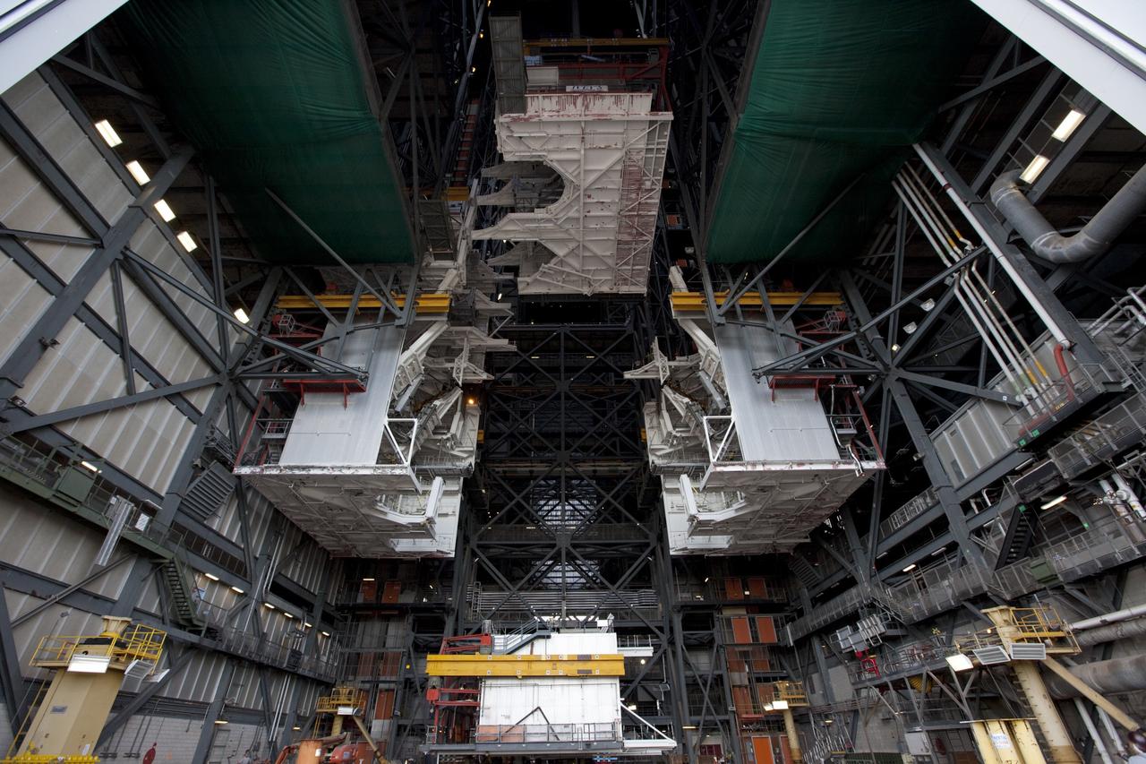 CAPE CANAVERAL, Fla. – At NASA’s Kennedy Space Center in Florida, a crane lowers a space shuttle-era work platform from high bay 3 inside the Vehicle Assembly Building, or VAB. The platform has been moved to the VAB north parking area for temporary storage. The work is part of a center-wide refurbishment initiative under the Ground Systems Development and Operations, or GSDO, Program. High bay 3 is being refurbished to accommodate NASA’s Space Launch System and a variety of other spacecraft. Photo credit: NASA/Kim Shiflett
