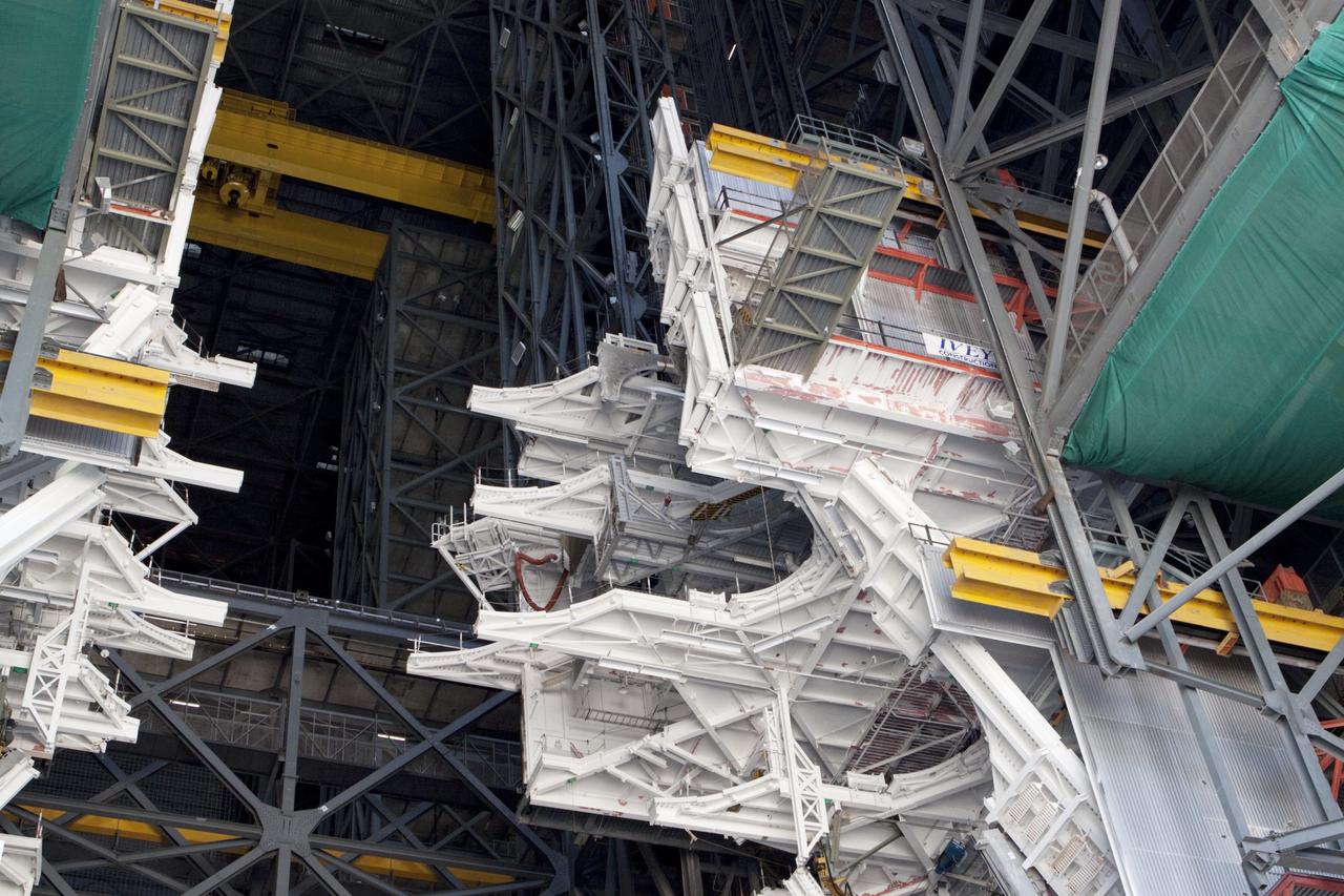 CAPE CANAVERAL, Fla. – At NASA’s Kennedy Space Center in Florida, a crane lowers a space shuttle-era work platform from high bay 3 inside the Vehicle Assembly Building, or VAB. The platform has been moved to the VAB north parking area for temporary storage. The work is part of a center-wide refurbishment initiative under the Ground Systems Development and Operations, or GSDO, Program. High bay 3 is being refurbished to accommodate NASA’s Space Launch System and a variety of other spacecraft. Photo credit: NASA/Kim Shiflett