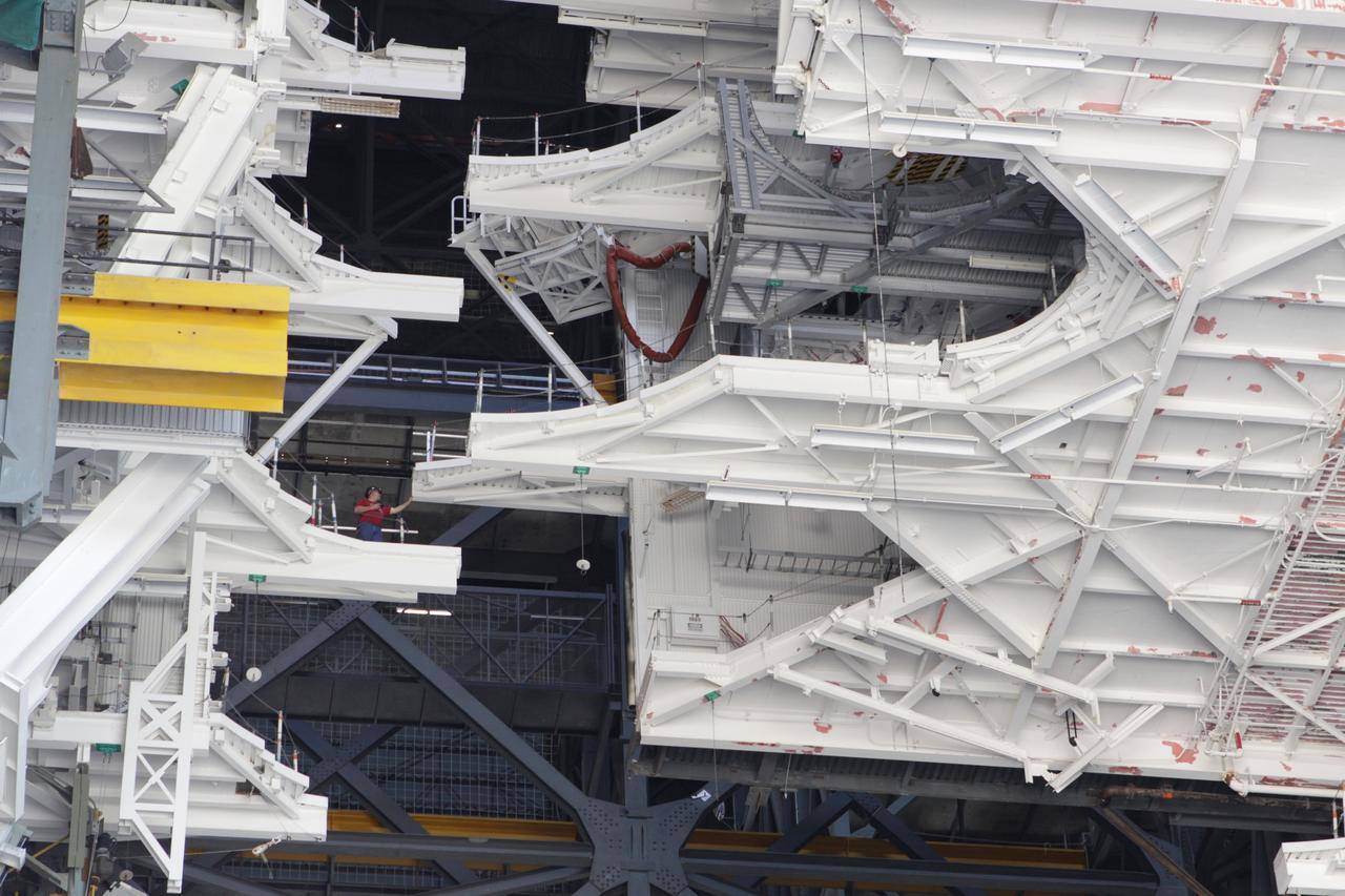 CAPE CANAVERAL, Fla. – At NASA’s Kennedy Space Center in Florida, a crane lowers a space shuttle-era work platform from high bay 3 inside the Vehicle Assembly Building, or VAB. The platform has been moved to the VAB north parking area for temporary storage. The work is part of a center-wide refurbishment initiative under the Ground Systems Development and Operations, or GSDO, Program. High bay 3 is being refurbished to accommodate NASA’s Space Launch System and a variety of other spacecraft. Photo credit: NASA/Kim Shiflett