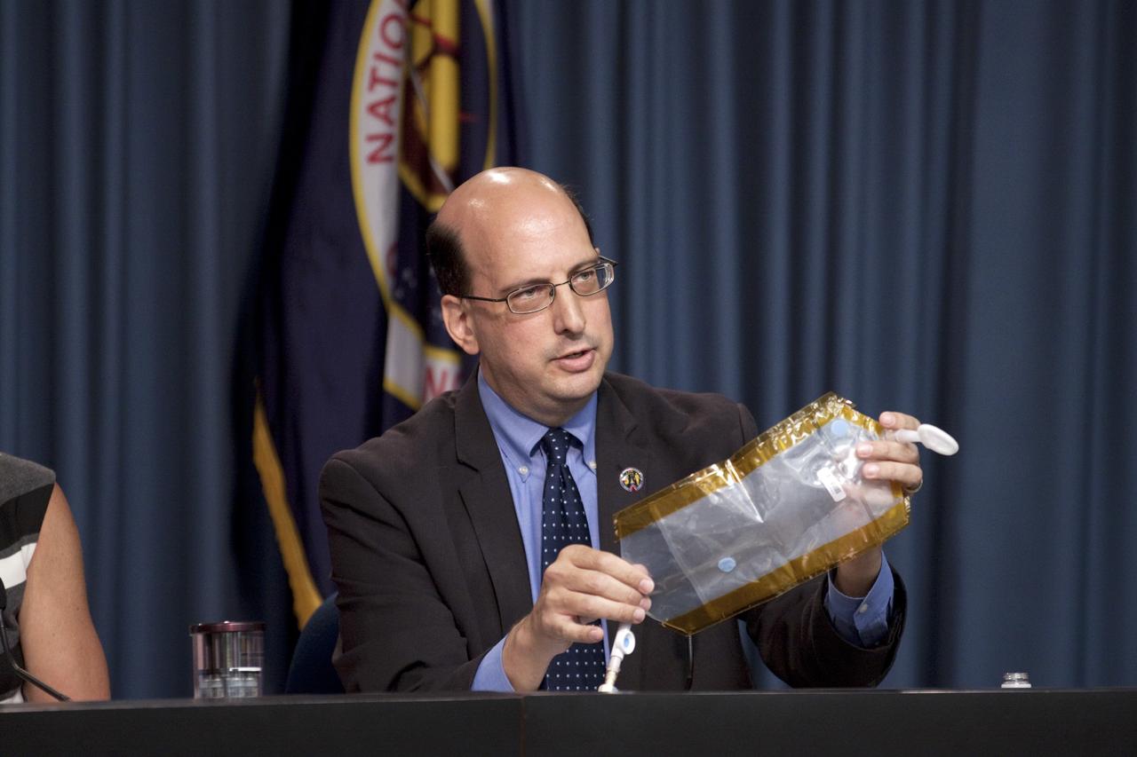 CAPE CANAVERAL, Fla. -- Scott Smith, NASA nutritionist at NASA's Johnson Space Center, explains one method of urine collection on the space station during a mission science briefing in Kennedy Space Center's Press Site auditorium in Florida.     The briefing provided media with an overview of the experiments and payloads scheduled for launch on NASA's first Commercial Resupply Services, or CRS-1, mission to the International Space Station. Space Exploration Technologies Corp., or SpaceX, built both the mission's Falcon 9 rocket and Dragon capsule. Launch is scheduled for 8:35 p.m. EDT on Oct. 7 from Space Launch Complex 40 on Cape Canaveral Air Force Station.  SpaceX CRS-1 is an important step toward making America’s microgravity research program self-sufficient by providing a way to deliver and return significant amounts of cargo, including science experiments, to and from the orbiting laboratory. NASA has contracted for 12 commercial resupply flights from SpaceX and eight from the Orbital Sciences Corp. For more information, visit http://www.nasa.gov/mission_pages/station/living/launch/index.html.  Photo credit: NASA/Kim Shiflett