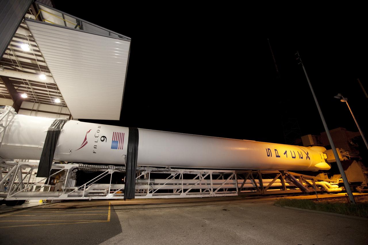 CAPE CANAVERAL, Fla. -- A Falcon 9 rocket with a Dragon capsule secured atop begins to roll from the processing hangar to the pad at Space Launch Complex 40 on Cape Canaveral Air Force Station in Florida.      Space Exploration Technologies Corp., or SpaceX, built both the rocket and capsule for NASA's first Commercial Resupply Services, or CRS-1, mission to the International Space Station.  Rollout was complete at 9:55 p.m. EDT.  SpaceX CRS-1 is an important step toward making America’s microgravity research program self-sufficient by providing a way to deliver and return significant amounts of cargo, including science experiments, to and from the orbiting laboratory. Launch is scheduled for 8:35 p.m. EDT on Oct. 7. NASA has contracted for 12 commercial resupply flights from SpaceX and eight from the Orbital Sciences Corp. For more information, visit http://www.nasa.gov/mission_pages/station/living/launch/index.html.  Photo credit: NASA/Kim Shiflett