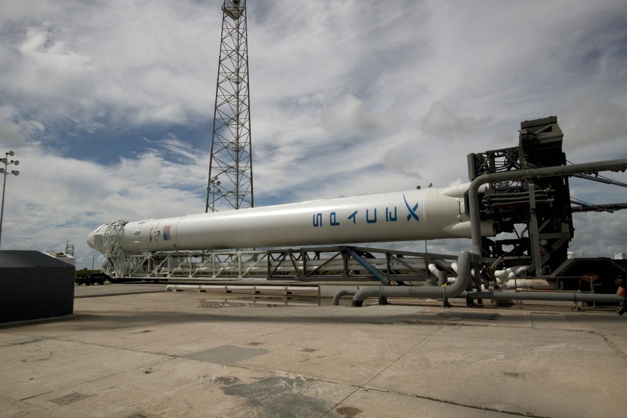 CAPE CANAVERAL, Fla. -- Preparations are under way to lift a Falcon 9 rocket with a Dragon capsule secured atop into a vertical position on the pad at Space Launch Complex 40 on Cape Canaveral Air Force Station in Florida.      Space Exploration Technologies Corp., or SpaceX, built both the rocket and capsule for NASA's first Commercial Resupply Services, or CRS-1, mission to the International Space Station.  The vertical lift was complete at 1 p.m. EDT.  SpaceX CRS-1 is an important step toward making America’s microgravity research program self-sufficient by providing a way to deliver and return significant amounts of cargo, including science experiments, to and from the orbiting laboratory. Launch is scheduled for 8:35 p.m. EDT on Oct. 7. NASA has contracted for 12 commercial resupply flights from SpaceX and eight from the Orbital Sciences Corp. For more information, visit http://www.nasa.gov/mission_pages/station/living/launch/index.html.  Photo credit: NASA/Jim Grossmann