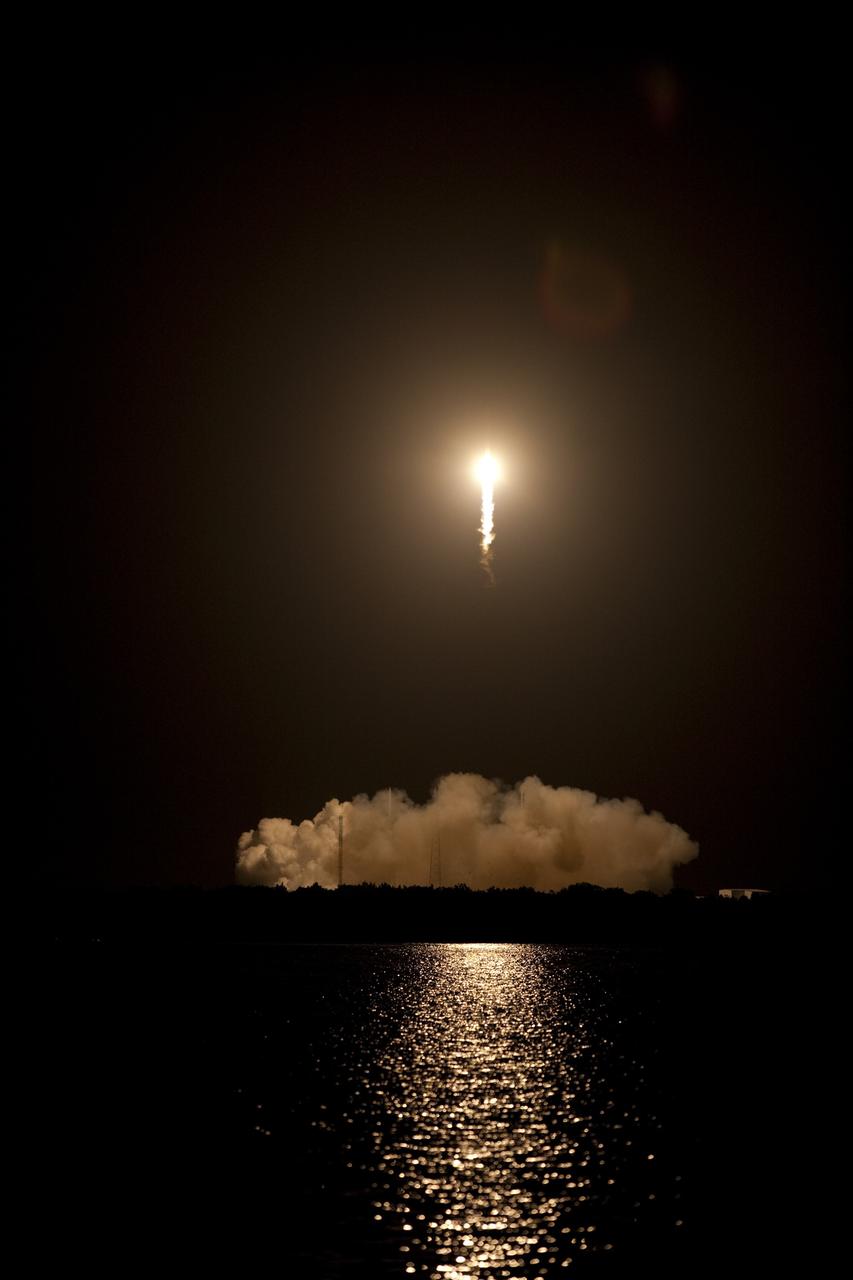 CAPE CANAVERAL, Fla. -- A Falcon 9 rocket cuts its way through the clouds over Space Launch Complex 40 on Cape Canaveral Air Force Station in Florida carrying a Dragon capsule to orbit. Launch was at 8:35 p.m. EDT.    Space Exploration Technologies Corp., or SpaceX, built both the rocket and capsule for NASA's first Commercial Resupply Services, or CRS-1, mission to the International Space Station. SpaceX CRS-1 is an important step toward making America’s microgravity research program self-sufficient by providing a way to deliver and return significant amounts of cargo, including science experiments, to and from the orbiting laboratory. NASA has contracted for 12 commercial resupply flights from SpaceX and eight from the Orbital Sciences Corp. For more information, visit http://www.nasa.gov/mission_pages/station/living/launch/index.html.  Photo credit: NASA/Glenn Benson