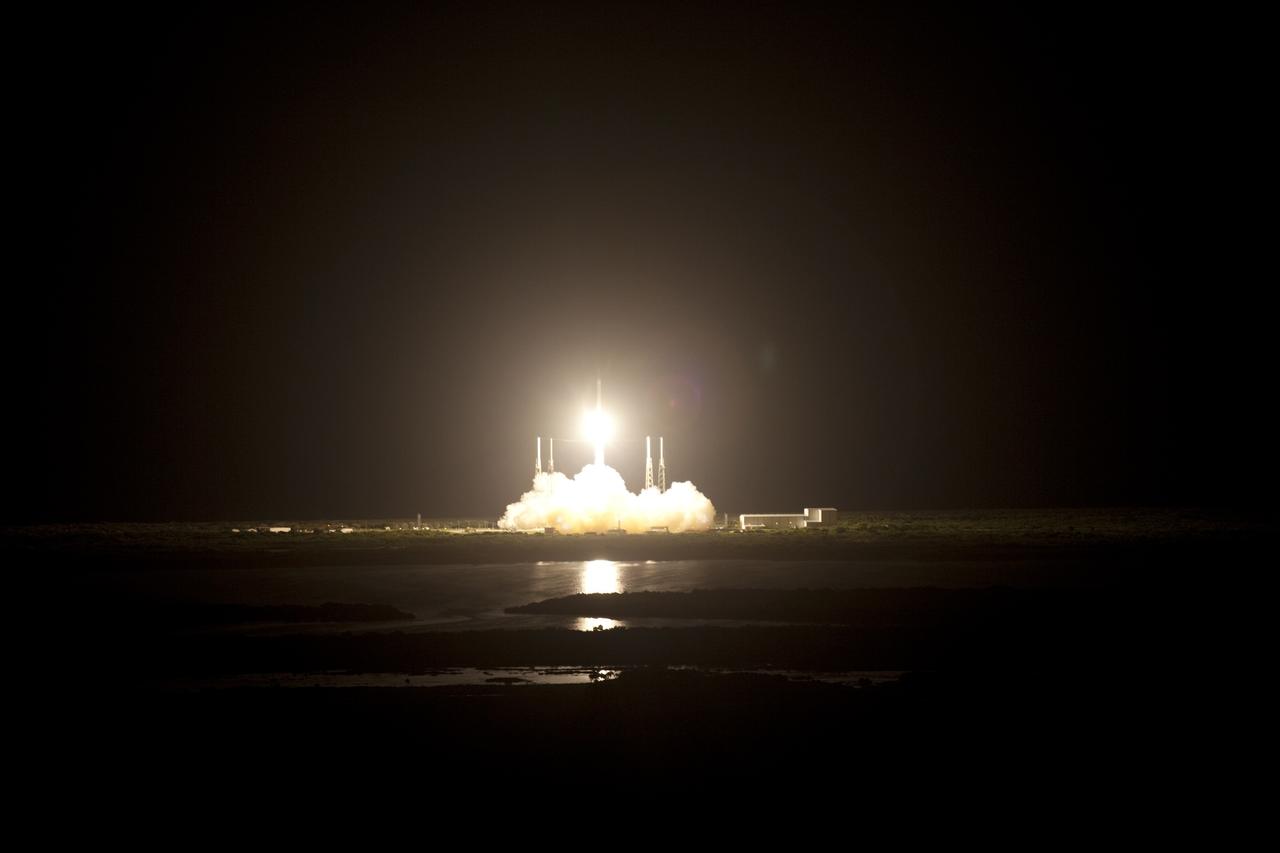 CAPE CANAVERAL, Fla. -- Plumes of exhaust and smoke billow around the lightning masts on Space Launch Complex 40 on Cape Canaveral Air Force Station in Florida as a Falcon 9 rocket lifts off at 8:35 p.m. EDT, carrying a Dragon capsule to orbit.    Space Exploration Technologies Corp., or SpaceX, built both the rocket and capsule for NASA's first Commercial Resupply Services, or CRS-1, mission to the International Space Station. SpaceX CRS-1 is an important step toward making America’s microgravity research program self-sufficient by providing a way to deliver and return significant amounts of cargo, including science experiments, to and from the orbiting laboratory. NASA has contracted for 12 commercial resupply flights from SpaceX and eight from the Orbital Sciences Corp. For more information, visit http://www.nasa.gov/mission_pages/station/living/launch/index.html.  Photo credit: NASA/Gianni Woods