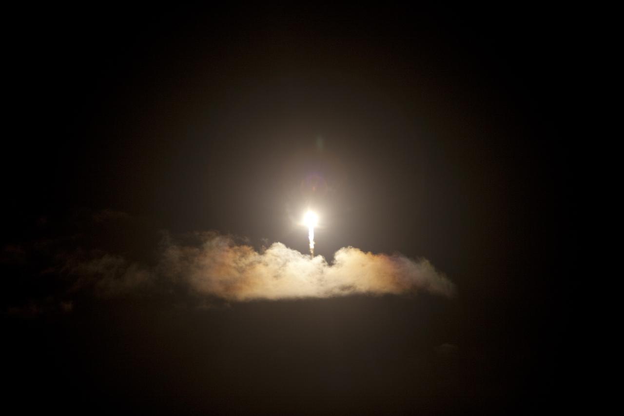 CAPE CANAVERAL, Fla. -- The clouds over Space Launch Complex 40 on Cape Canaveral Air Force Station in Florida light up as a Falcon 9 rocket passes through, carrying a Dragon capsule to orbit. Liftoff was at 8:35 p.m. EDT.    Space Exploration Technologies Corp., or SpaceX, built both the rocket and capsule for NASA's first Commercial Resupply Services, or CRS-1, mission to the International Space Station. SpaceX CRS-1 is an important step toward making America’s microgravity research program self-sufficient by providing a way to deliver and return significant amounts of cargo, including science experiments, to and from the orbiting laboratory. NASA has contracted for 12 commercial resupply flights from SpaceX and eight from the Orbital Sciences Corp. For more information, visit http://www.nasa.gov/mission_pages/station/living/launch/index.html.  Photo credit: NASA/Gianni Woods