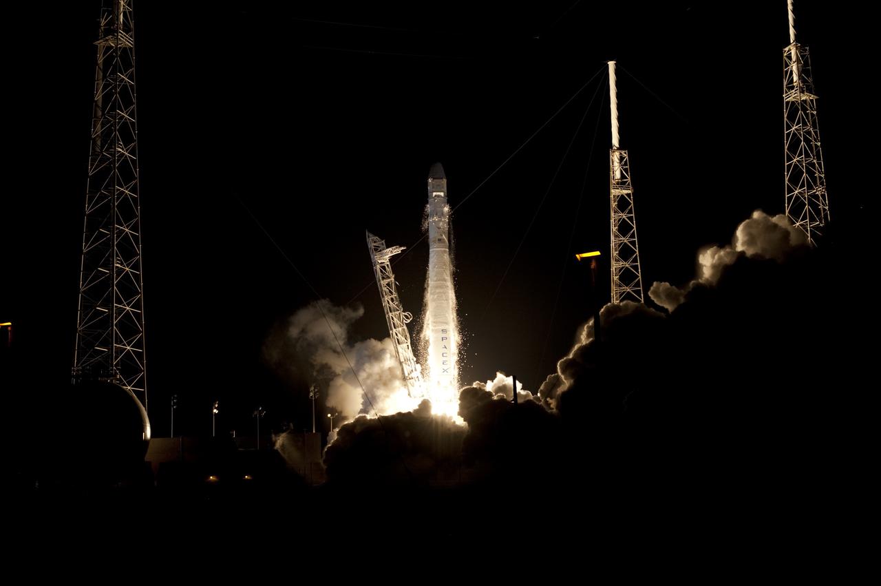 CAPE CANAVERAL, Fla. -- Plumes of exhaust and smoke form around a Falcon 9 rocket at 8:35 p.m. EDT as it lifts off Space Launch Complex 40 on Cape Canaveral Air Force Station in Florida, carrying a Dragon capsule to orbit.    Space Exploration Technologies Corp., or SpaceX, built both the rocket and capsule for NASA's first Commercial Resupply Services, or CRS-1, mission to the International Space Station. SpaceX CRS-1 is an important step toward making America’s microgravity research program self-sufficient by providing a way to deliver and return significant amounts of cargo, including science experiments, to and from the orbiting laboratory. NASA has contracted for 12 commercial resupply flights from SpaceX and eight from the Orbital Sciences Corp. For more information, visit http://www.nasa.gov/mission_pages/station/living/launch/index.html.  Photo credit: NASA/Tony Gray and Rick Wetherington