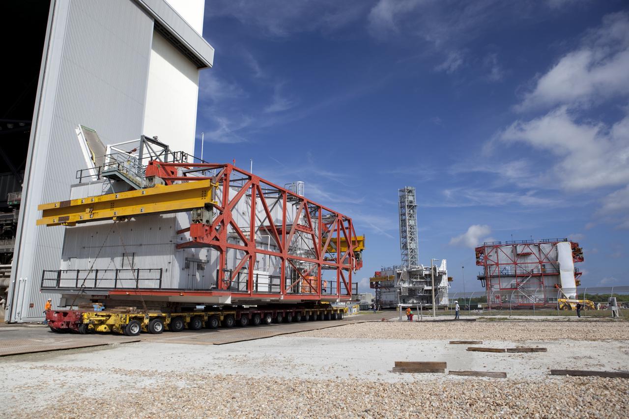 CAPE CANAVERAL, Fla. – As part of NASA's Ground Systems Development and Operations Program at the Kennedy Space Center in Florida, a large space shuttle-era work platform is being removed by transporter from high bay 3 of the Vehicle Assembly Building, or VAB. The work is part of a center-wide modernization and refurbishment initiative to accommodate NASA’s Space Launch System and a variety of other spacecraft instead of the whole building supporting one design. The Ground Systems Development and Operations Program is developing the necessary ground systems, infrastructure and operational approaches required to safely process, assemble, transport and launch the next generation of rockets and spacecraft in support of NASA’s exploration objectives. Future work also will replace the antiquated communications, power and vehicle access resources with modern efficient systems. Some of the utilities and systems slated for replacement have been used since the VAB opened in 1965. For more information, visit http://www.nasa.gov/exploration/systems/ground/index.html Photo credit: NASA/Dimitri Gerondidakis