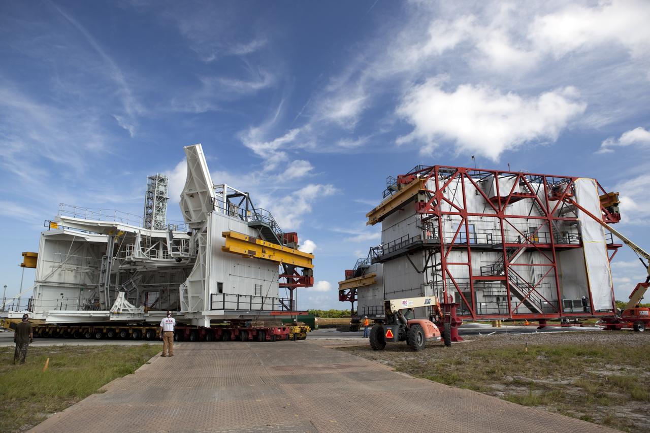CAPE CANAVERAL, Fla. – As part of NASA's Ground Systems Development and Operations Program at the Kennedy Space Center in Florida, a technician oversees a large space shuttle-era work platform being removed by transporter from high bay 3 of the Vehicle Assembly Building, or VAB. The work is part of a center-wide modernization and refurbishment initiative to accommodate NASA’s Space Launch System and a variety of other spacecraft instead of the whole building supporting one design. The Ground Systems Development and Operations Program is developing the necessary ground systems, infrastructure and operational approaches required to safely process, assemble, transport and launch the next generation of rockets and spacecraft in support of NASA’s exploration objectives. Future work also will replace the antiquated communications, power and vehicle access resources with modern efficient systems. Some of the utilities and systems slated for replacement have been used since the VAB opened in 1965. For more information, visit http://www.nasa.gov/exploration/systems/ground/index.html Photo credit: NASA/Dimitri Gerondidakis