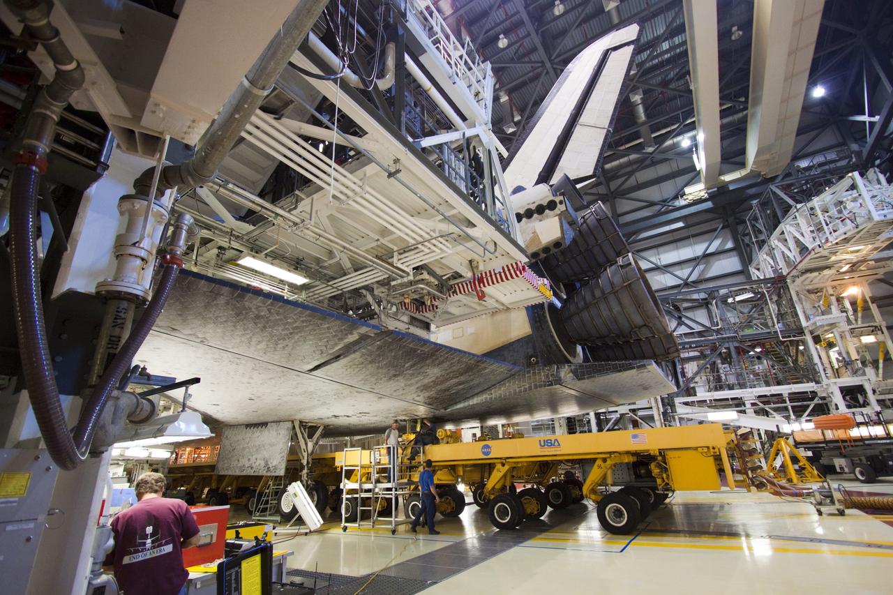 CAPE CANAVERAL, Fla. – Space shuttle Atlantis is loaded onto the orbiter transporter vehicle in Orbiter Processing Facility-2 at NASA's Kennedy Space Center in Florida. The shuttle is being prepared for its move from the OPF to the Vehicle Assembly Building during transition and retirement work. Later, the shuttle will be taken to the Kennedy Space Center Visitor Complex where it will go on public display. Photo credit: NASA/Jim Grossmann