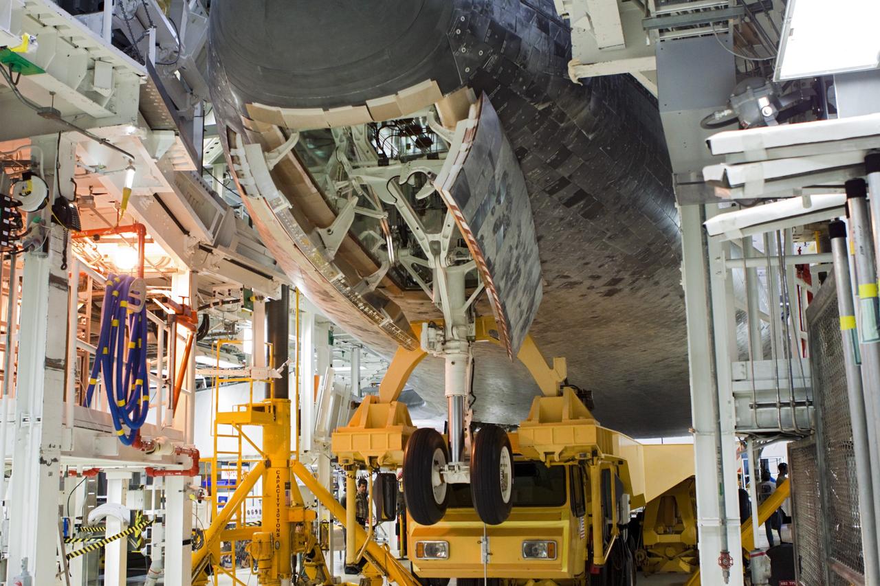 CAPE CANAVERAL, Fla. – Space shuttle Atlantis is loaded onto the orbiter transporter vehicle in Orbiter Processing Facility-2 at NASA's Kennedy Space Center in Florida. The shuttle is being prepared for its move from the OPF to the Vehicle Assembly Building during transition and retirement work. Later, the shuttle will be taken to the Kennedy Space Center Visitor Complex where it will go on public display. Photo credit: NASA/Jim Grossmann