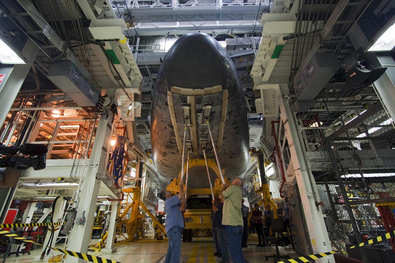 CAPE CANAVERAL, Fla. – Technicians close the doors to the nose gear of space shuttle Atlantis as the shuttle sits on the orbiter transporter vehicle in Orbiter Processing Facility-2 at NASA's Kennedy Space Center in Florida. The shuttle is being prepared for its move from the OPF to the Vehicle Assembly Building during transition and retirement work. Later, the shuttle will be taken to the Kennedy Space Center Visitor Complex where it will go on public display. Photo credit: NASA/Jim Grossmann