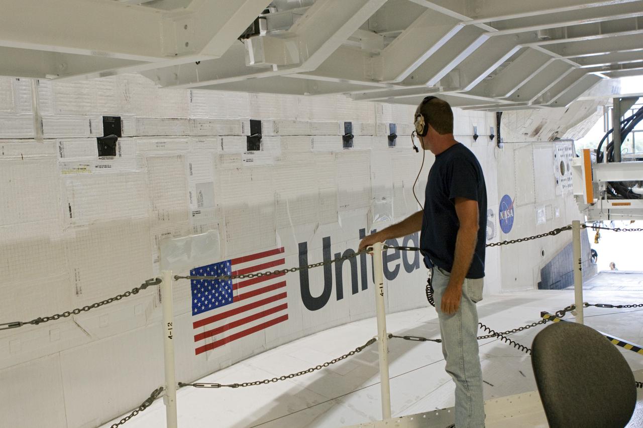 CAPE CANAVERAL, Fla. – A technician watches as space shuttle Atlantis moves from Orbiter Processing Facility-2 to the Vehicle Assembly Building at NASA's Kennedy Space Center in Florida. Atlantis will be moved to the Kennedy Space Center Visitor Complex in November where it will be put on public display. Photo credit: NASA/Jim Grossmann