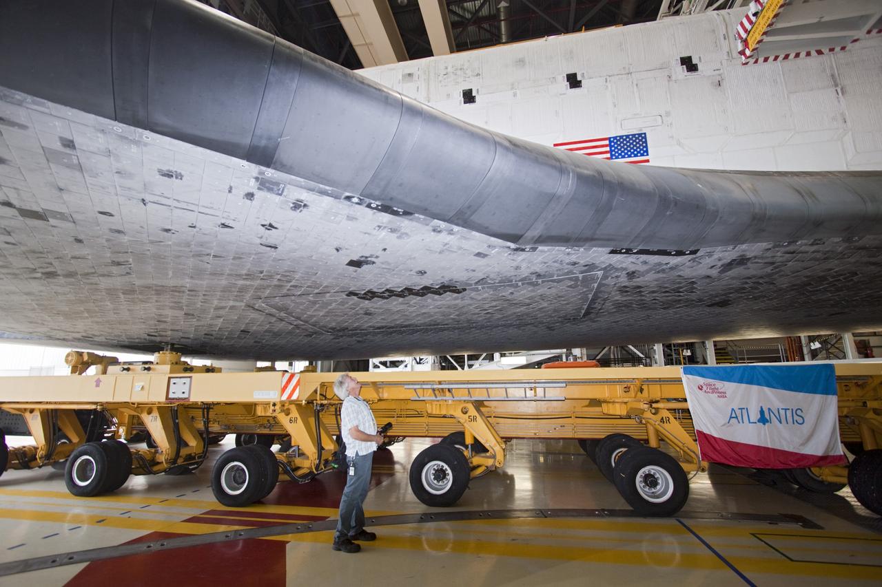 CAPE CANAVERAL, Fla. – A technician watches as space shuttle Atlantis moves from Orbiter Processing Facility-2 to the Vehicle Assembly Building at NASA's Kennedy Space Center in Florida. Atlantis will be moved to the Kennedy Space Center Visitor Complex in November where it will be put on public display. Photo credit: NASA/Jim Grossmann