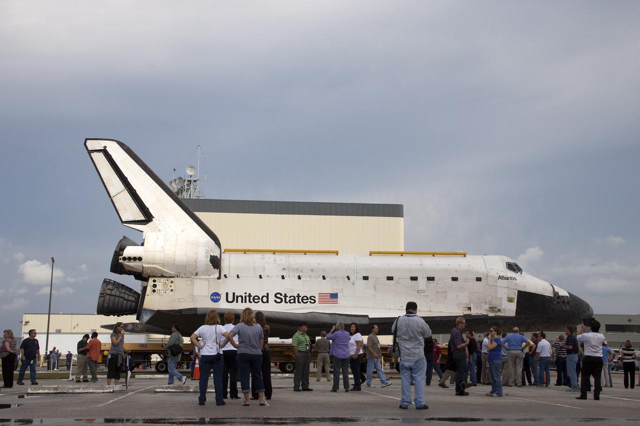 CAPE CANAVERAL, Fla. – Employees at NASA's Kennedy Space Center in Florida watch as the space shuttle Atlantis moves from Orbiter Processing Facility-2 to the Vehicle Assembly Building. Atlantis will be moved to the Kennedy Space Center Visitor Complex in November where it will be placed on public display. Photo credit: NASA/Jim Grossmann
