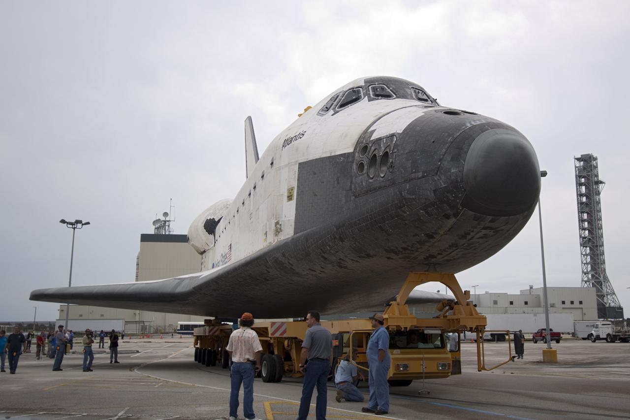 CAPE CANAVERAL, Fla. – United Space Alliance technicians at NASA's Kennedy Space Center in Florida monitor the space shuttle Atlantis as it moves from Orbiter Processing Facility-2 to the Vehicle Assembly Building. Atlantis will be moved to the Kennedy Space Center Visitor Complex in November where it will be placed on public display. Photo credit: NASA/Jim Grossmann