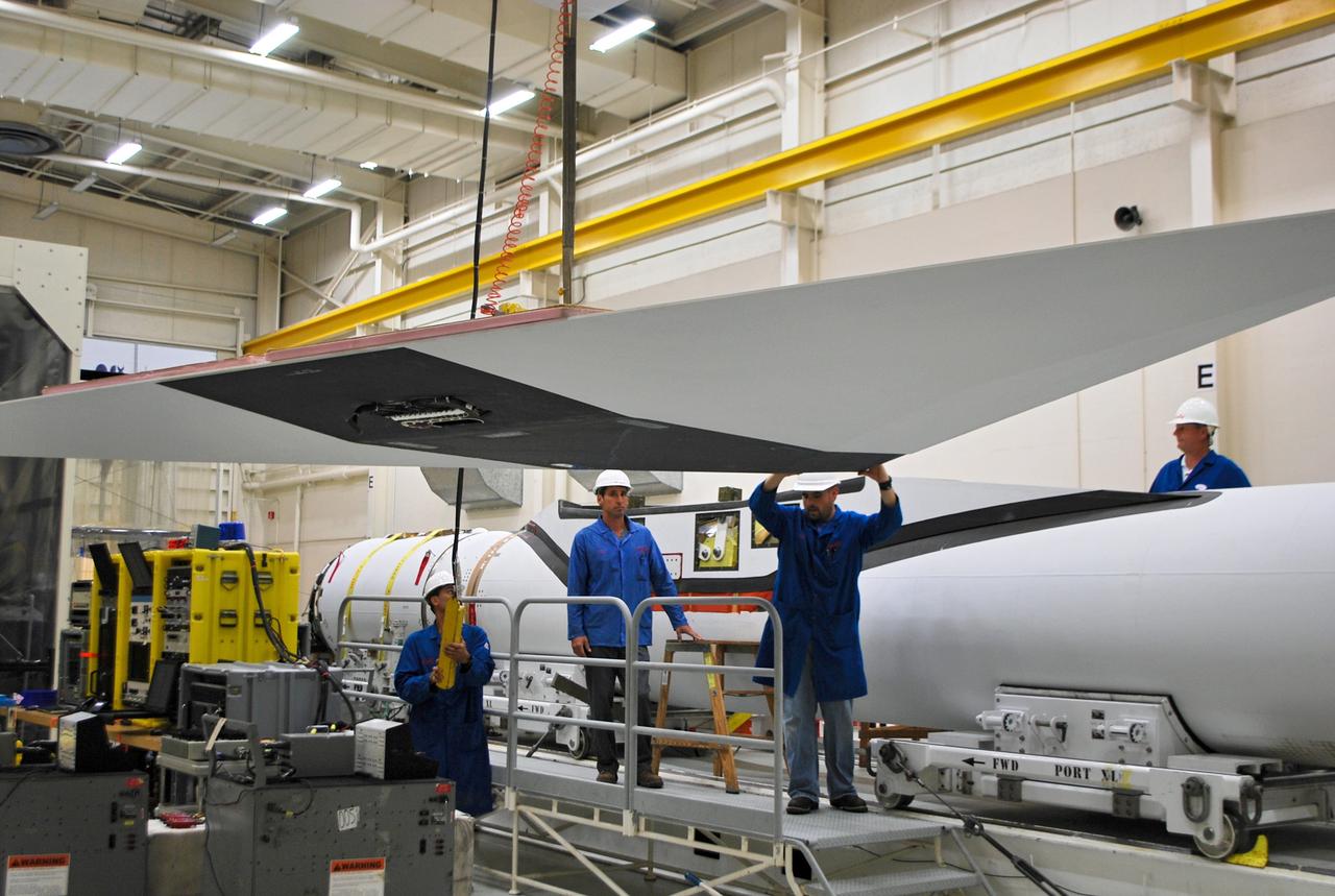 VANDENBERG AIR FORCE BASE, Calif. – At Vandenberg Air Force Base in California, technicians prepare to install the wing on the Orbital Sciences Corp. Pegasus XL rocket which will launch the Interface Region Imaging Spectrograph, or IRIS, spacecraft.      Scheduled for launch from Vandenberg Air Force Base no earlier than Feb. 27, 2013, IRIS will open a new window of discovery by tracing the flow of energy and plasma through the chromospheres and transition region into the sun’s corona using spectrometry and imaging. IRIS fills a crucial gap in our ability to advance studies of the sun-to-Earth connection by tracing the flow of energy and plasma through the foundation of the corona and the region around the sun known as the heliosphere. For more information, visit http://iris.gsfc.nasa.gov Photo credit: NASA/Randy Beaudoin