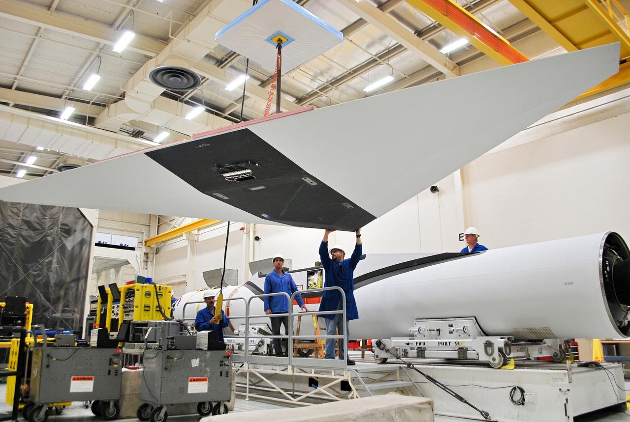 VANDENBERG AIR FORCE BASE, Calif. – At Vandenberg Air Force Base in California, technicians install the wing on the Orbital Sciences Corp. Pegasus XL rocket which will launch the Interface Region Imaging Spectrograph, or IRIS, spacecraft.      Scheduled for launch from Vandenberg Air Force Base no earlier than Feb. 27, 2013, IRIS will open a new window of discovery by tracing the flow of energy and plasma through the chromospheres and transition region into the sun’s corona using spectrometry and imaging. IRIS fills a crucial gap in our ability to advance studies of the sun-to-Earth connection by tracing the flow of energy and plasma through the foundation of the corona and the region around the sun known as the heliosphere. For more information, visit http://iris.gsfc.nasa.gov Photo credit: NASA/Randy Beaudoin