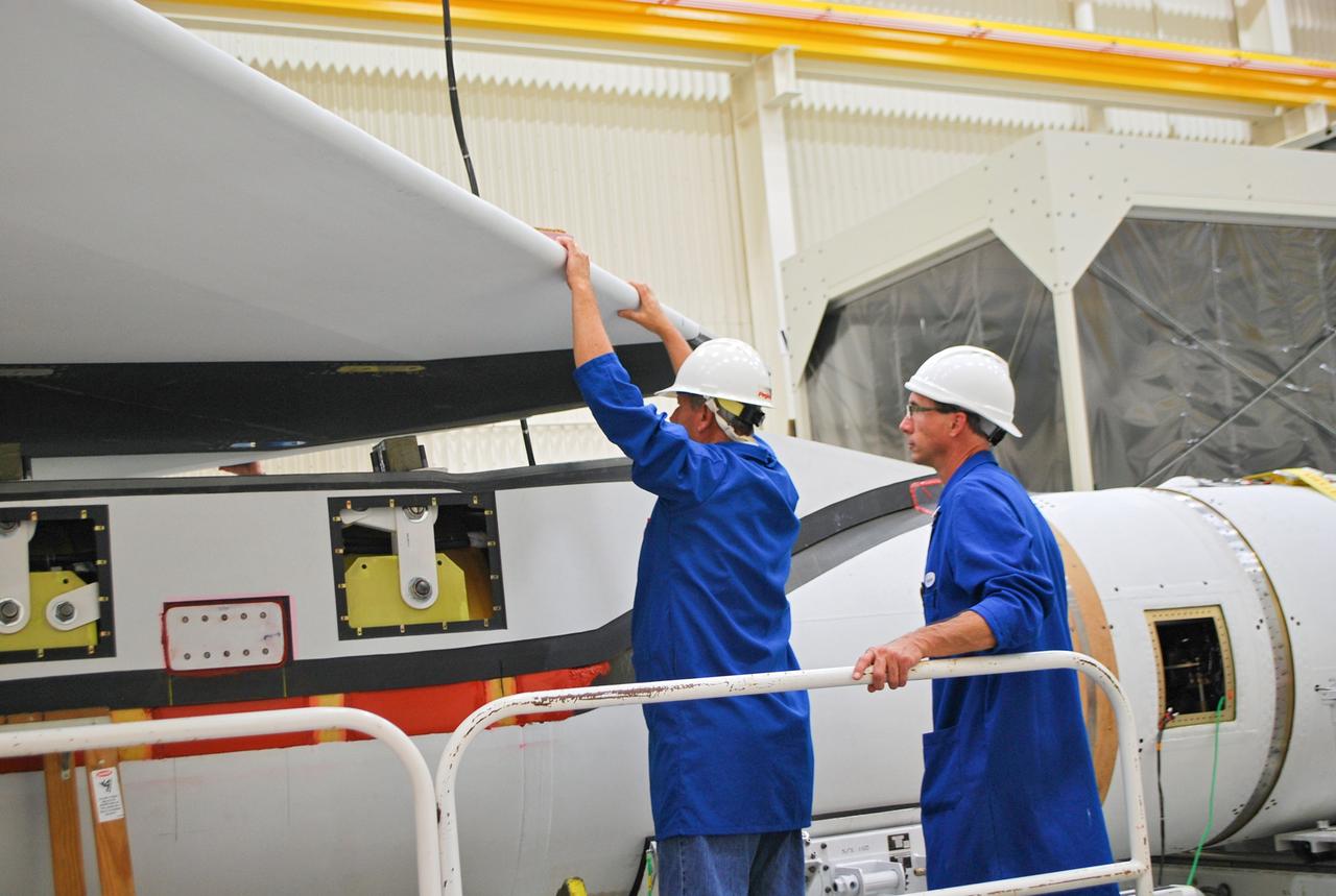 VANDENBERG AIR FORCE BASE, Calif. – At Vandenberg Air Force Base in California, technicians install the wing on the Orbital Sciences Corp. Pegasus XL rocket which will launch the Interface Region Imaging Spectrograph, or IRIS, spacecraft.      Scheduled for launch from Vandenberg Air Force Base no earlier than Feb. 27, 2013, IRIS will open a new window of discovery by tracing the flow of energy and plasma through the chromospheres and transition region into the sun’s corona using spectrometry and imaging. IRIS fills a crucial gap in our ability to advance studies of the sun-to-Earth connection by tracing the flow of energy and plasma through the foundation of the corona and the region around the sun known as the heliosphere. For more information, visit http://iris.gsfc.nasa.gov Photo credit: NASA/Randy Beaudoin