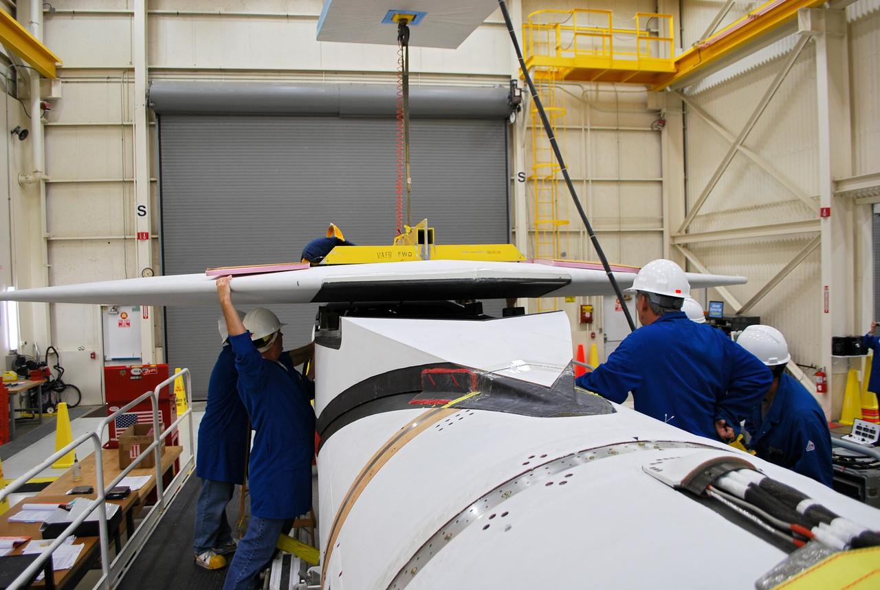 VANDENBERG AIR FORCE BASE, Calif. – At Vandenberg Air Force Base in California, technicians install the wing on the Orbital Sciences Corp. Pegasus XL rocket which will launch the Interface Region Imaging Spectrograph, or IRIS, spacecraft.      Scheduled for launch from Vandenberg Air Force Base no earlier than Feb. 27, 2013, IRIS will open a new window of discovery by tracing the flow of energy and plasma through the chromospheres and transition region into the sun’s corona using spectrometry and imaging. IRIS fills a crucial gap in our ability to advance studies of the sun-to-Earth connection by tracing the flow of energy and plasma through the foundation of the corona and the region around the sun known as the heliosphere. For more information, visit http://iris.gsfc.nasa.gov Photo credit: NASA/Randy Beaudoin