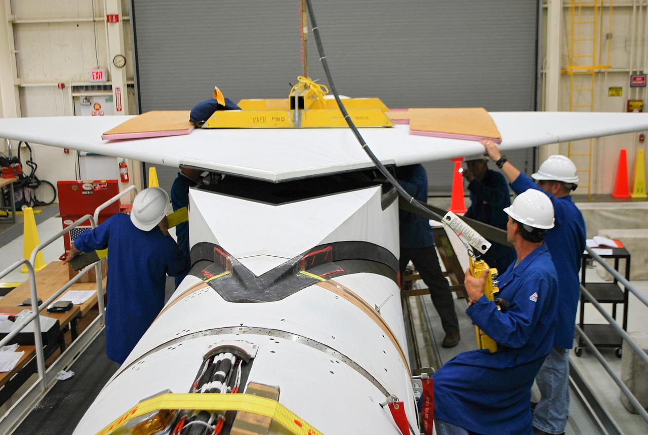 VANDENBERG AIR FORCE BASE, Calif. – At Vandenberg Air Force Base in California, technicians install the wing on the Orbital Sciences Corp. Pegasus XL rocket which will launch the Interface Region Imaging Spectrograph, or IRIS, spacecraft.      Scheduled for launch from Vandenberg Air Force Base no earlier than Feb. 27, 2013, IRIS will open a new window of discovery by tracing the flow of energy and plasma through the chromospheres and transition region into the sun’s corona using spectrometry and imaging. IRIS fills a crucial gap in our ability to advance studies of the sun-to-Earth connection by tracing the flow of energy and plasma through the foundation of the corona and the region around the sun known as the heliosphere. For more information, visit http://iris.gsfc.nasa.gov Photo credit: NASA/Randy Beaudoin