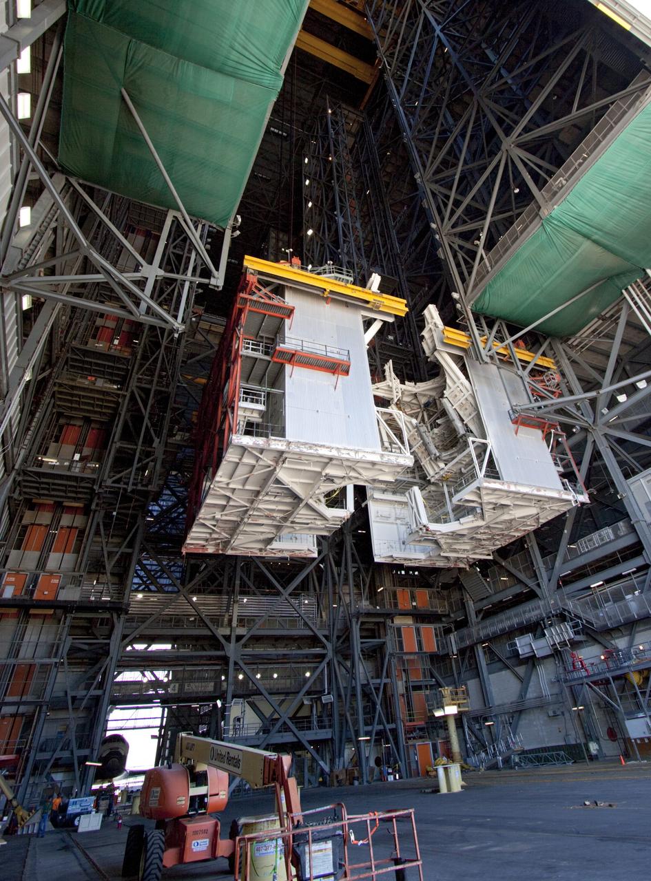 CAPE CANAVERAL, Fla. – As part of NASA's Ground Systems Development and Operations Program at the Kennedy Space Center in Florida, a large space shuttle-era work platform is being removed from high bay 3 of the Vehicle Assembly Building, or VAB. The work is part of a center-wide modernization and refurbishment initiative to accommodate NASA’s Space Launch System and a variety of other spacecraft instead of the whole building supporting one design. Visible in the lower-left background is the space shuttle Atlantis being readied for its move to the Kennedy Space Center Visitor Complex.       The Ground Systems Development and Operations Program is developing the necessary ground systems, infrastructure and operational approaches required to safely process, assemble, transport and launch the next generation of rockets and spacecraft in support of NASA’s exploration objectives. Future work also will replace the antiquated communications, power and vehicle access resources with modern efficient systems. Some of the utilities and systems slated for replacement have been used since the VAB opened in 1965. For more information, visit http://www.nasa.gov/exploration/systems/ground/index.html Photo credit: NASA/Jim Grossmann
